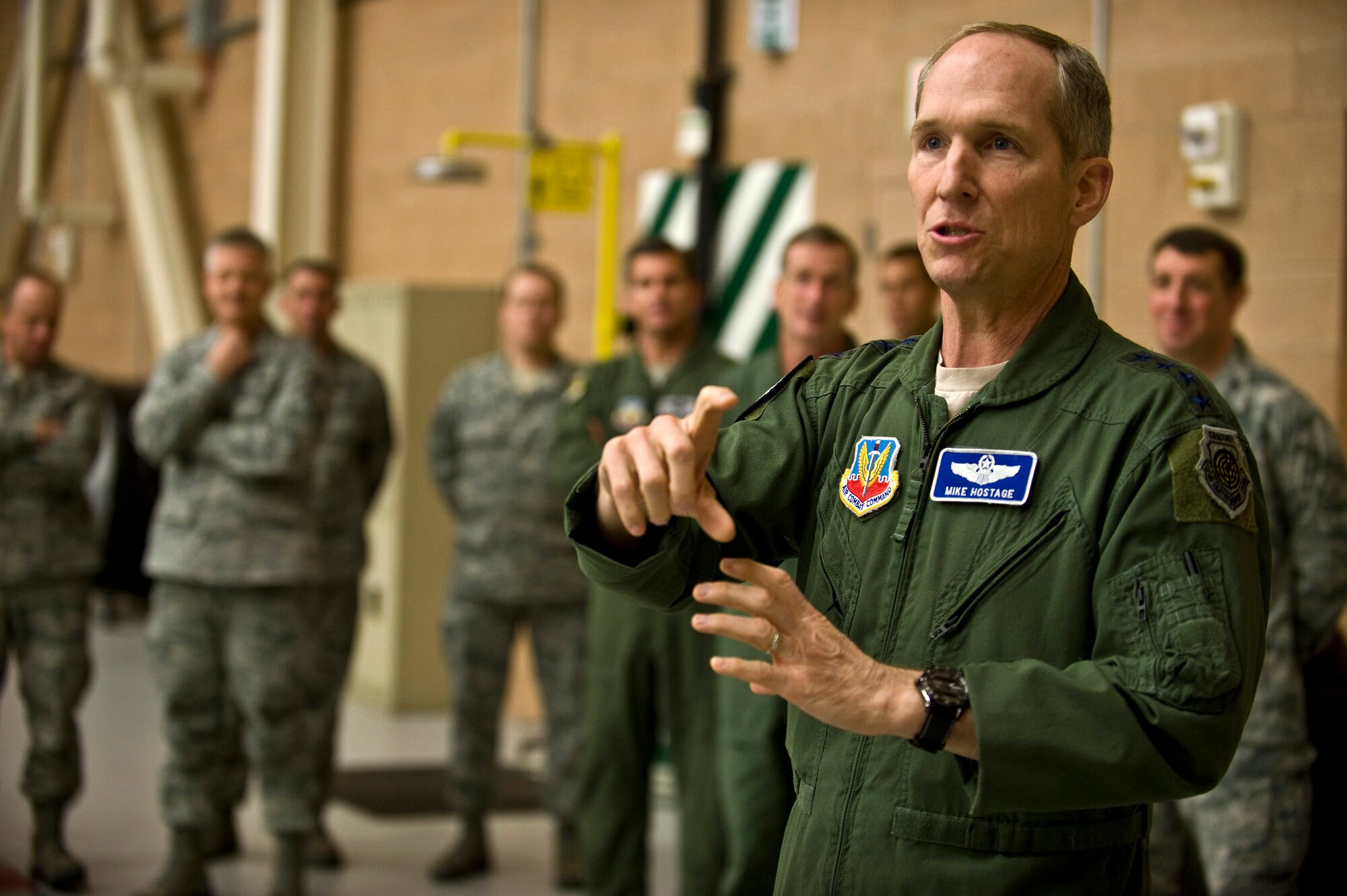 U.S. Air Force Gen. Mike Hostage, commander of Air Combat Command, addresses Airmen of the 57th Aircraft Maintenance Squadron on current events Jan. 11, 2012, inside the Viper Aircraft Maintenance Unit hangar at Nellis Air Force Base, Nev. As the commander, he is responsible for organizing, training, equipping and maintaining combat-ready forces for rapid deployment and employment while ensuring strategic air defense forces are ready to meet the challenges of peacetime air sovereignty and wartime defense. (U.S. Air Force photo by Senior Airman Brett Clashman/Released)
