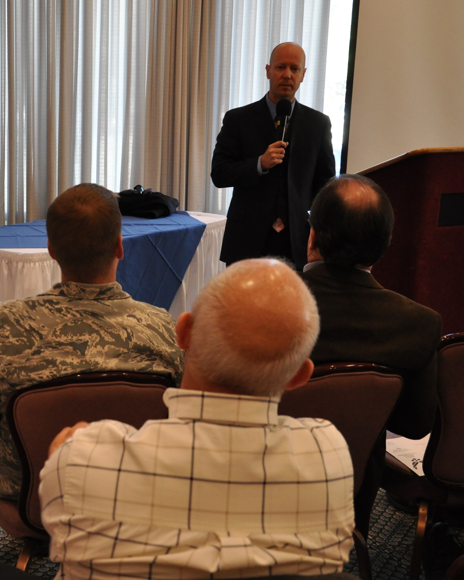 Mr. Chris Smith, 325th Force Support Squadron civilian personnel office, briefs Team Tyndall members Jan. 13 during a town hall meeting at the Heritage Club. The meeting was called to address Air Force Appropriated Fund Civilian Department of Defense Force Efficiencies. The Air Force is offering a second round of voluntary early retirement authority and voluntary separation incentive pay that began Jan. 9. The move is part of the Air Force's continuing effort to meet the Department of Defense requirement to maintain civilian funding at fiscal 2010 levels. (U.S. Air Force photo by Senior Airman Rachelle Elsea)