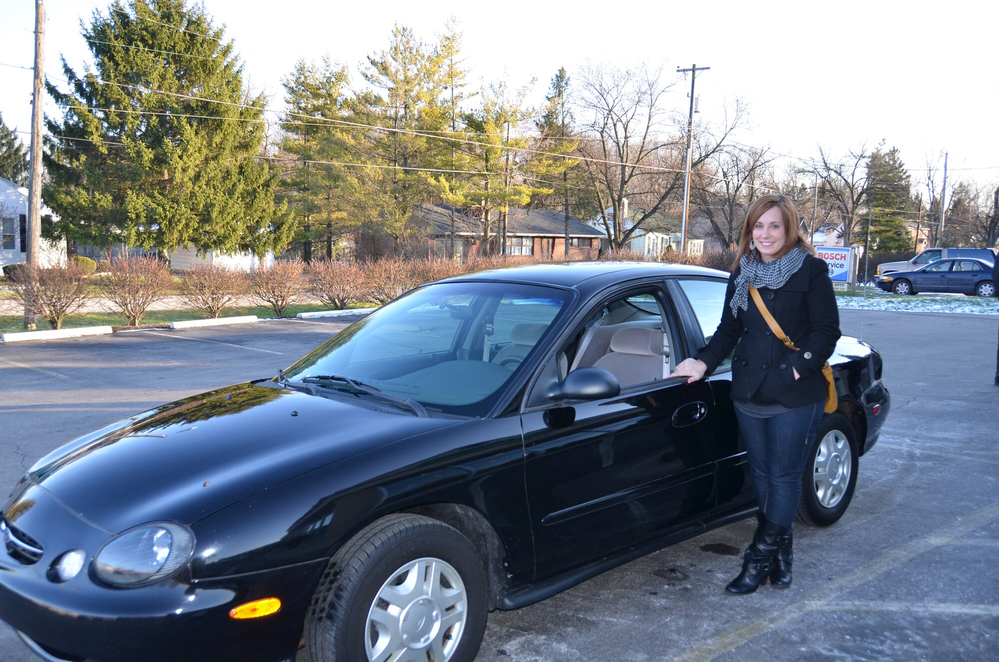 WRIGHT-PATTERSON AIR FORCE BASE, Ohio – Staff Sgt. Traci Todahl, 445th Aeromedical Staging Squadron mental health technician, stands outside her new Ford Taurus Jan. 4. The car was donated by Murphy’s Autocare of Beavercreek, Ohio, as part of the Charity Cars program. Dave and Jan Murphy, owners of Murphy’s Autocare, along with other organizations are participants in the Charity Cars program that donates vehicles to those who are in need. This is the third vehicle the Murphys have donated to a member of the wing. (U.S. Air Force photo/Lt. Col. Cynthia Harris)