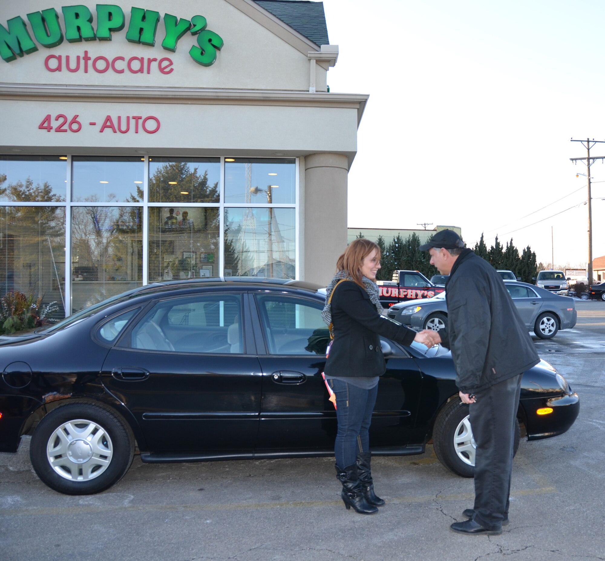 WRIGHT-PATTERSON AIR FORCE BASE, Ohio – Staff Sgt. Traci Todahl, 445th Aeromedical Staging Squadron mental health technician, receives the keys to a Ford Taurus Jan. 4 from Don Sword, service manager from Murphy’s Autocare of Beavercreek, Ohio, as part of the Charity Cars program. Dave and Jan Murphy, owners of Murphy’s Autocare, along with other organizations are participants in the Charity Cars program that donates vehicles to those who are in need. This is the third vehicle the Murphys have donated to a member of the wing. (U.S. Air Force photo/Lt. Col. Cynthia Harris)