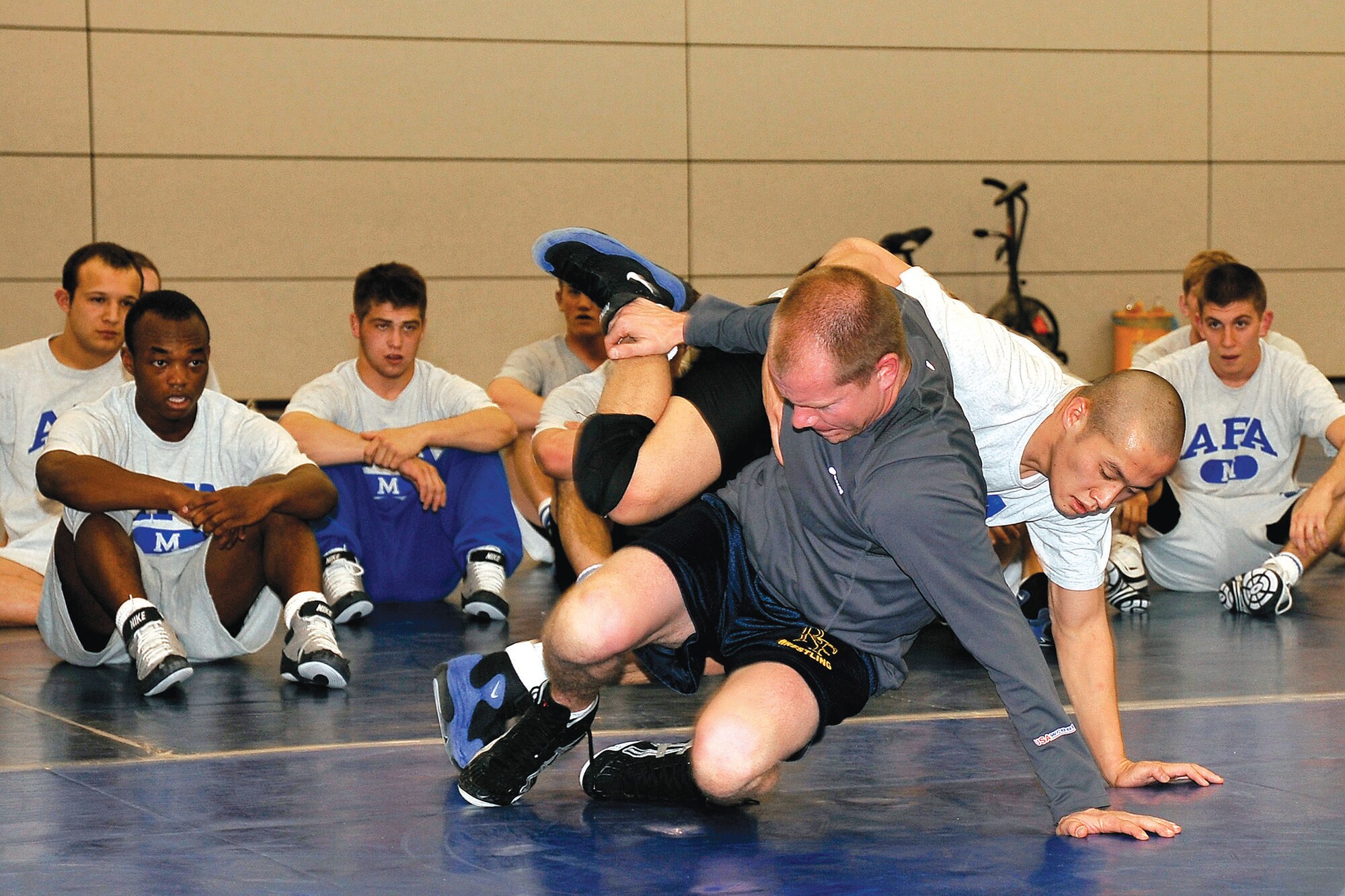 Tony Black demonstrates a move for the Air Force wrestling team. Black was an All-American at the University of Wisconsin at Madison. He was invited by Joel Sharratt, the Falcons’ head coach, to become the volunteer wrestling coach at the Air Force Academy. (U.S. Air Force Photo/Elizabeth Andrews)