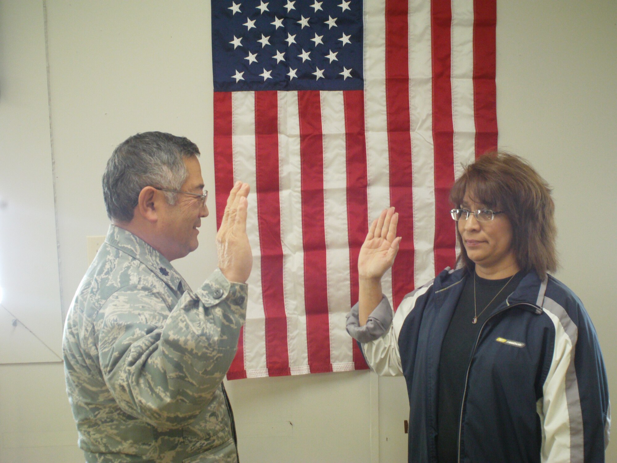 Airman 1st Class Clara Truly is the first local recruit to be sworn in by Lt. Col. Ron Soejoto during their first Unit Training Assembly Dec. 10, 2011 at Sheppard Air Force Base, Texas. The 4th Air Wing, Texas State Guard and Sheppard Air Force Base signed a memorandum of agreement Nov. 17, and stood up a new unit at Sheppard assigned to the 482nd Air Support Group. (U.S. Air Force courtesy photo)