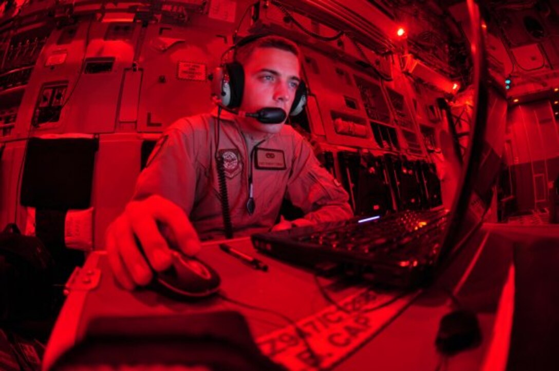 Staff Sgt. Robert Tingle, 62nd Aircraft Maintenance flying crew chief, conducts a review of an electronic checklist before taking off during a mission Sept. 10, 2009. The responsibility of a flying crew chief, or FCC, is to travel with cargo airlift to locations that do not have maintenance capabilities. Averages of 20 missions per week are split between the 62nd AW’s 47 certified FCCs. (U.S. Air Force photo/Staff Sgt. Robert Tingle)