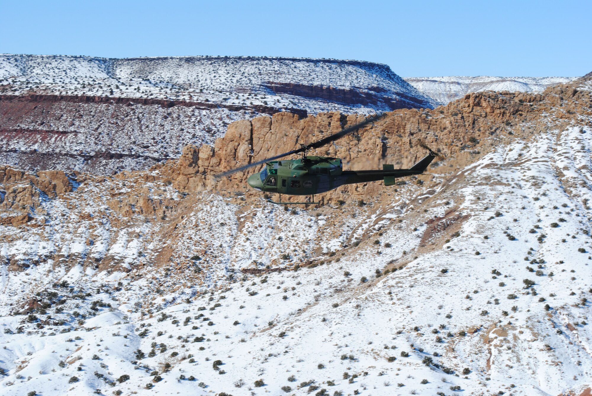A UH-1N assigned to the 512th Rescue Squadron banks left during a flight Dec. 27. U.S. Air Force Photo by John Cochran.