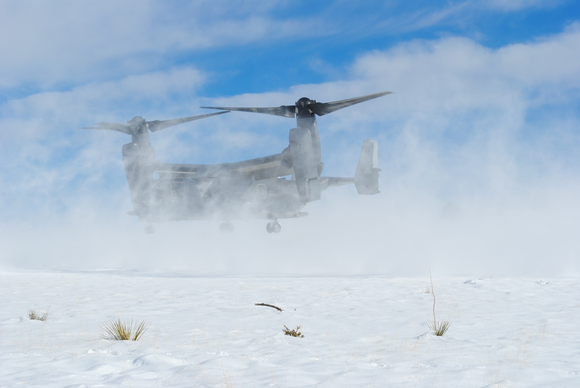 A CV-22 assigned to the 71st Special Operations Squadron scatters snow during a landing Dec. 28. U.S. Air 