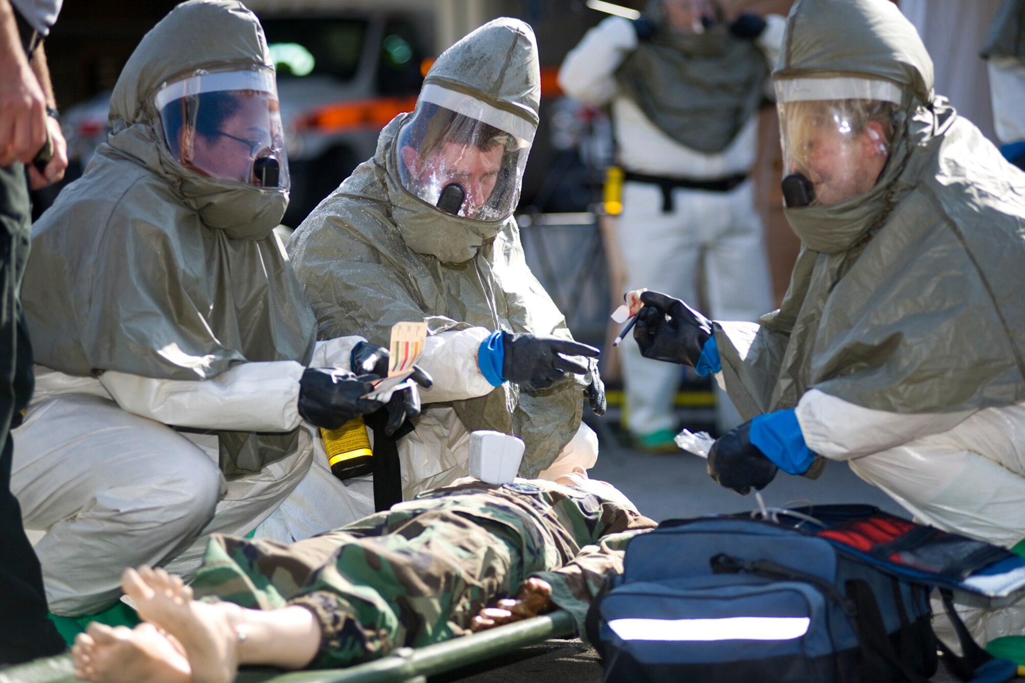 From left, 1st Lt. Sharon Eleby, 81st Medical Operations Squadron, and Capt. (Dr.) John Dusenbury and Senior Airman Sagan Barber, 81st Dental Squadron, triage a “simulated patient” and determine the type of agent they’re dealing with during decontamination training, Dec. 19-21, 2011 at Keesler Air Force Base, Miss.  Students had to adequately identify agents and decontaminate the patient in order to pass.  (U.S. Air Force photo by Adam Bond)