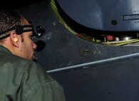 MINOT AIR FORCE BASE, N.D -- Staff Sgt. Jesus Virola Martinez, 5th Aircraft Maintenance Squadron aircraft weapon armament specialist, observes a B-52H Stratofortress munitions download operation here Jan. 11. Munitions downloads are performed monthly to ensure proficiency and certification of weapon specialists. (U.S. Air Force photo/Senior Airman Desiree W. Esposito) 