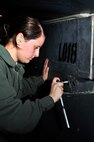 MINOT AIR FORCE BASE, N.D -- Airman Alyssa Mills, 5th Aircraft Maintenance Squadron aircraft weapon armament apprentice, uses a ratchet to remove the bolt from a buffet fairing on a B-52H Stratofortress during a munitions download operation here Jan. 11. Munitions downloads are performed monthly to ensure proficiency and certification of weapon specialists. (U.S. Air Force photo/Senior Airman Desiree W. Esposito)