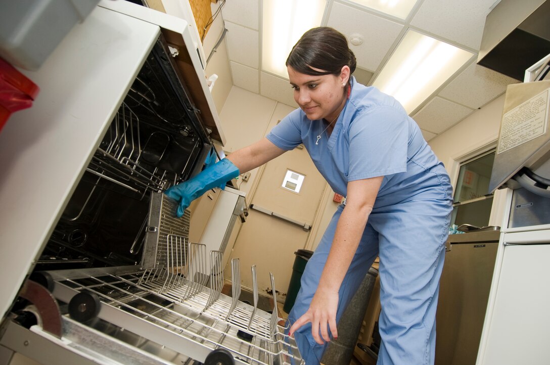 Senior Airman Christan Quarrell, 779th Dental Squadron dental prophylaxis technician, loads dental kits into a Meili dishwasher as the first procedure in infection control at the Dental Instrument Processing Center Jan. 10.   (Photo /Bobby Jones)