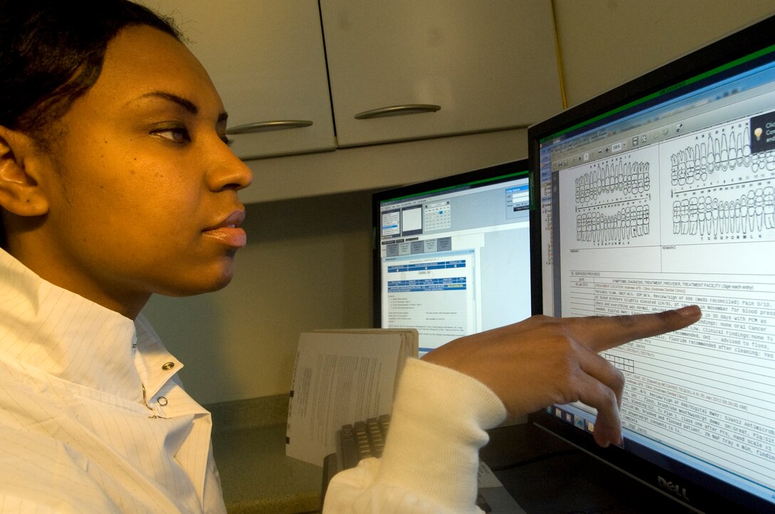 Staff Sgt. Nathiea Jacks, 779th Dental Squadron NCO in charge, reviews dental records for accuracy at the 779 DS clinic Jan. 10.   (Photo /Bobby Jones)