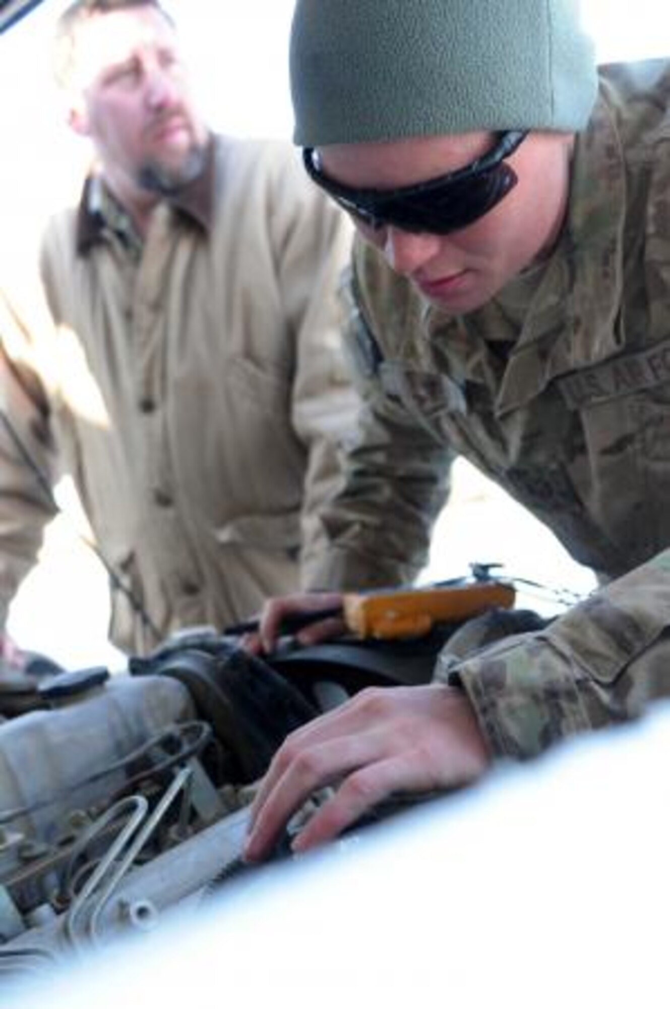 U.S. Air Force Staff Sgt Corrie Walden, Paktya Provincial Reconstruction Team vehicle maintainer from Bothell, Wash., inspects a vehicle in Paktya Province, Jan. 6. Walden is deployed from Shaw Air Force Base, S.C. (U.S. Air Force photo by 1st Lt. Cammie Quinn)