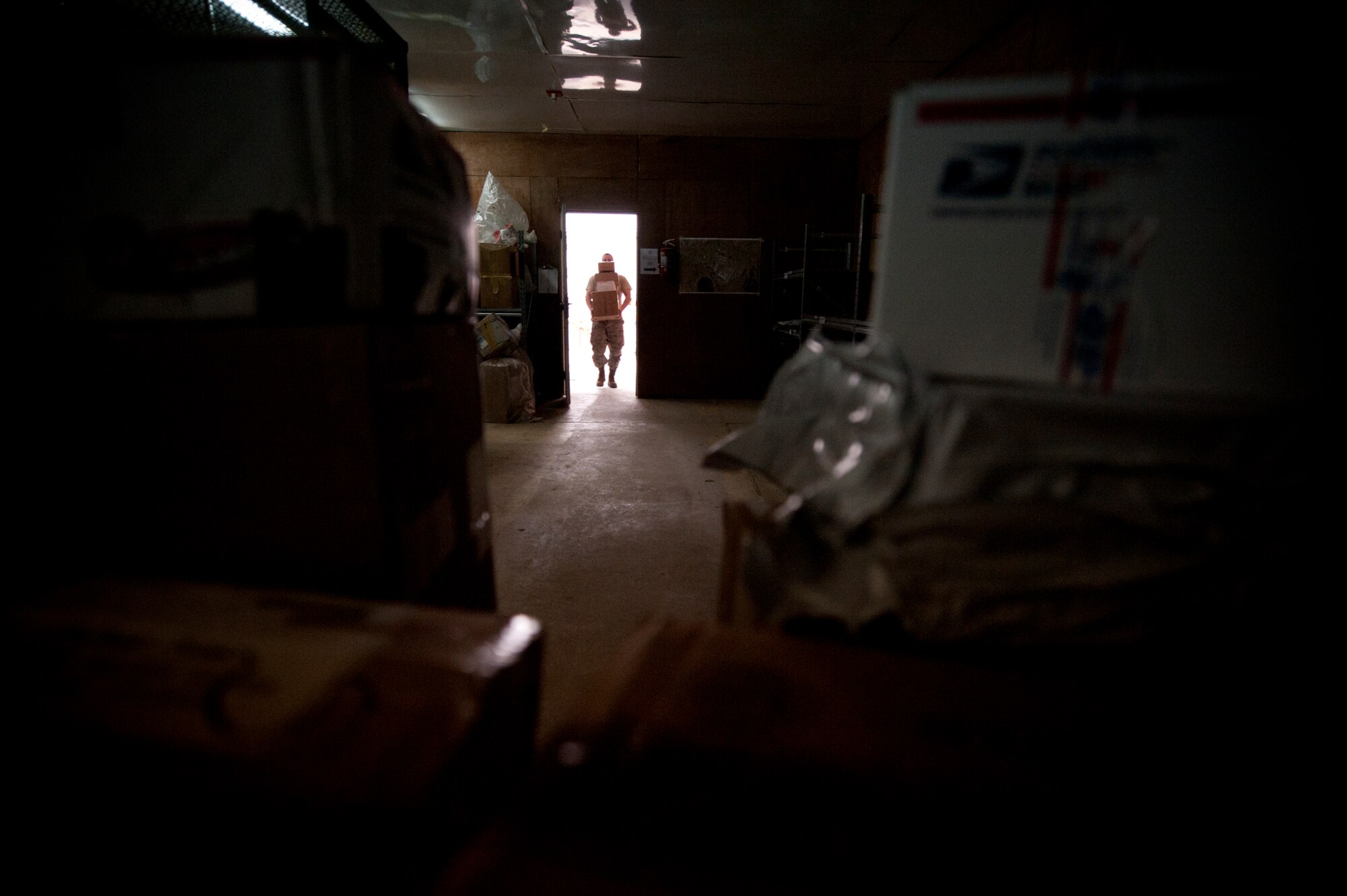 Tech. Sgt. David Boyd, 332nd Expeditionary Communication Squadron post master, brings in mail from a delivery truck at an undisclosed location in Southwest Asia, Jan. 13, 2012. Mail is delivered on a daily basis and ranges from a few pieces of mail to more than 300 packages a day. Boyd is deployed from Spangdahlem Air Base, Germany. (U.S. Air Force photo by Staff Sgt. Joshua J. Garcia/Released)