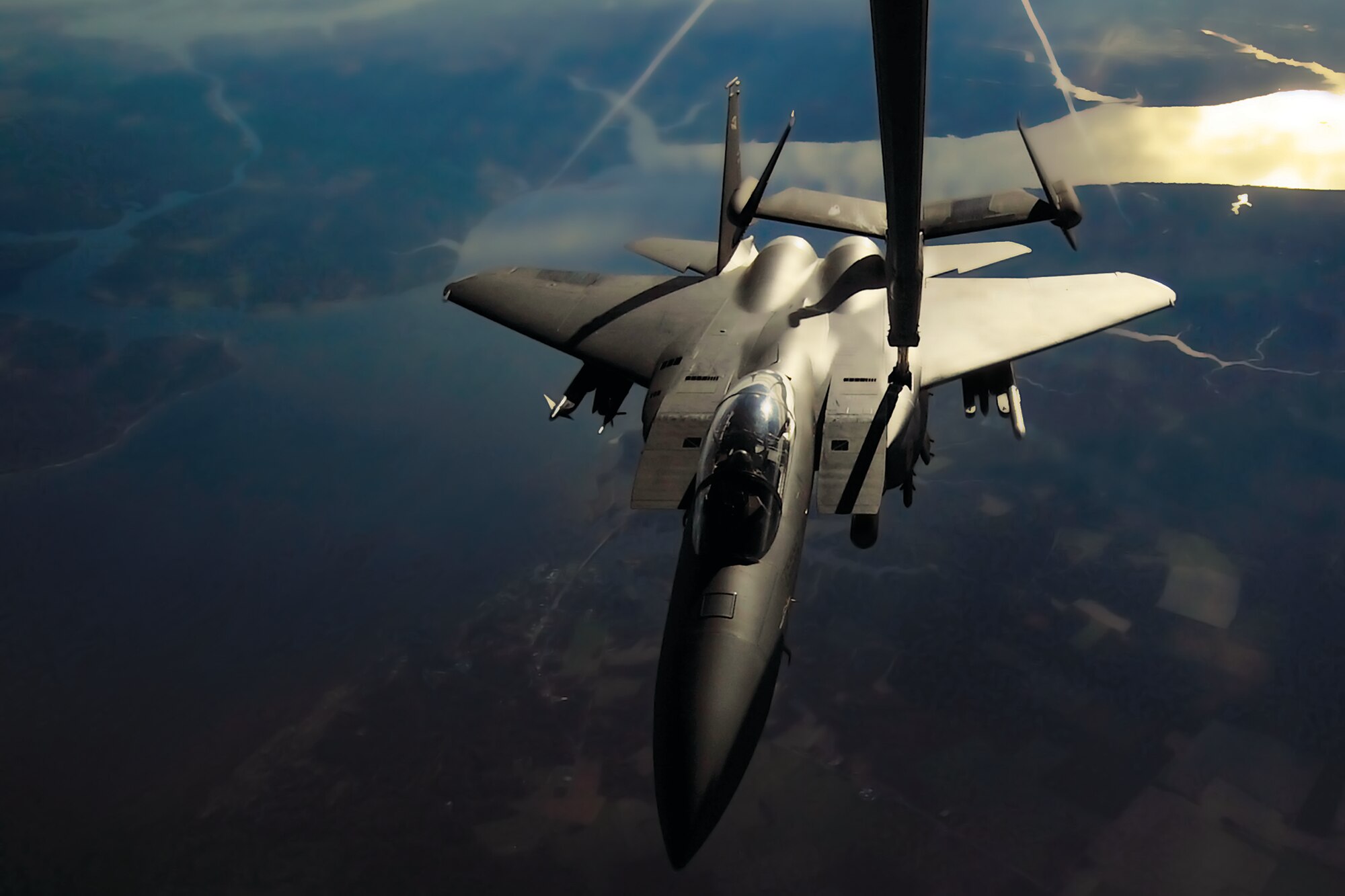 The refueling boom of a KC-10 Extender meets an F-15E Strike Eagle mid-air
above North Carolina's Outer Banks region Jan. 10. The boom was operated by
Tech. Sgt. Matthew Yockey, a reservist with the 78th Aerial Refueling
Squadron. The KC-10 and its aircrew proved their versatility during the
three-day mission that saw them transport passengers and humanitarian cargo
in addition to providing the Strike Eagles' fuel. The Strike Eagle and its
aircrew are stationed at Seymour Johnson Air Force Base, N.C.  (U.S. Air
Force photo by Shawn J. Jones)