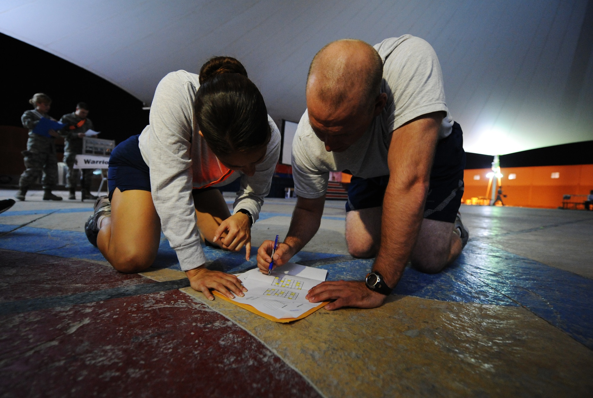 SOUTHWEST ASIA – Staff Sergeants Lee Torres (left) and Jonathan Tanner, both from the 379th Expeditionary Security Forces Squadron, solve a math puzzle during the Warrior Challenge here Jan. 11, 2012. The event consisted of games, riddles, and obstacles that reflected the four components of Comprehensive Airman Fitness---physical, social, spiritual and mental. The purpose of the event was to increase awareness of CAF and to help promote a wingman culture. Torres, a native of Orlando, is deployed from Altus Air Force Base, Okla. Tanner, a native of Sylva, N.C., is deployed from Royal Air Force Mildenhall, England. (U.S. Air Force photo/Staff Sgt. Nathanael Callon)
