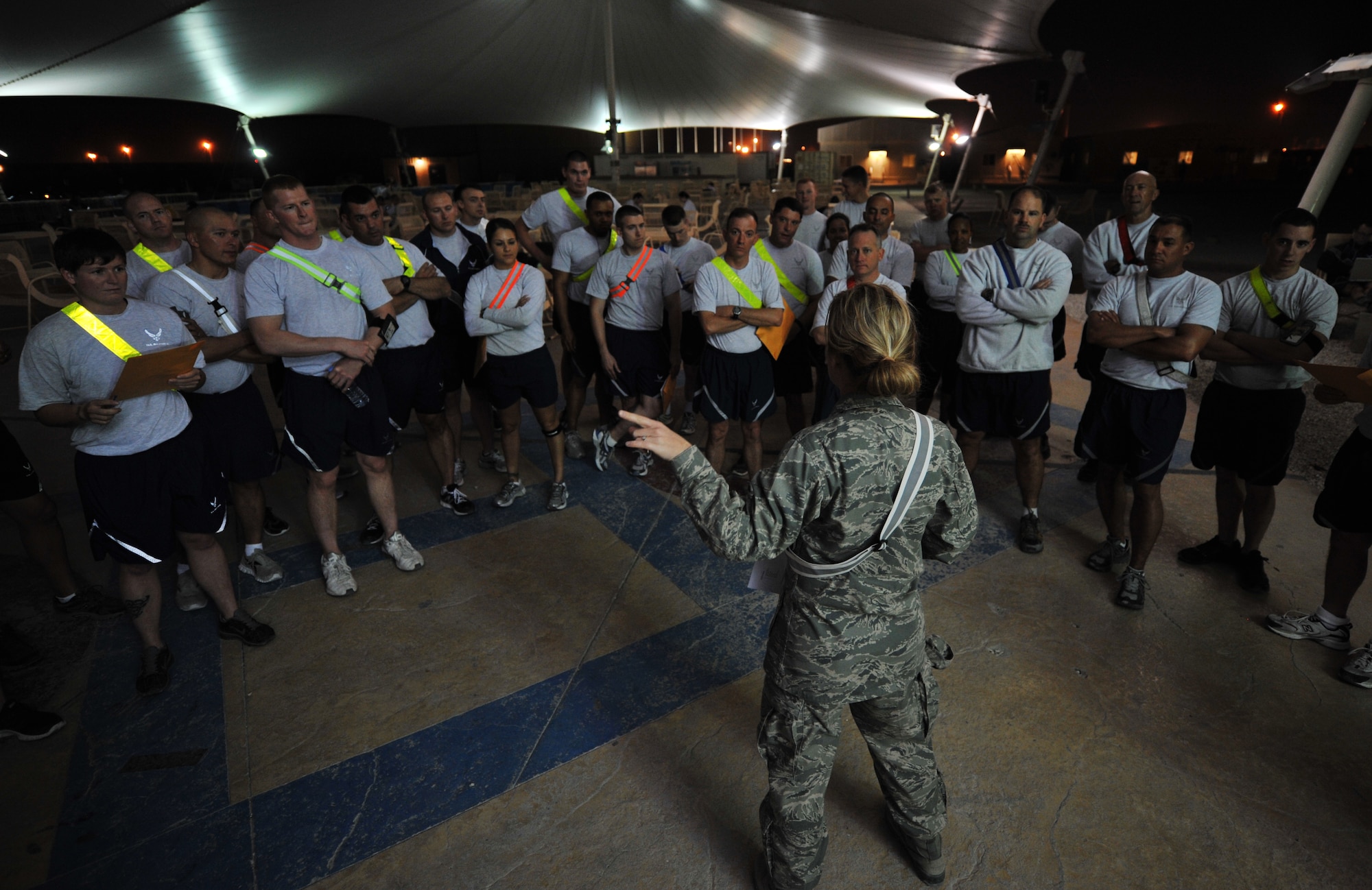 SOUTHWEST ASIA – Maj. Jennifer Kraus, Warrior Challenge event organizer and native of Buffalo, N.Y., explains the event route to participants here Jan. 11, 2012. The event consisted of games, riddles, and obstacles that reflected the four components of Comprehensive Airman Fitness---physical, social, spiritual and mental. The purpose of the event was to increase awareness of CAF and to help promote a wingman culture. Kraus is deployed from Niagara Falls Air Guard Station, N.Y. (U.S. Air Force photo/Staff Sgt. Nathanael Callon)