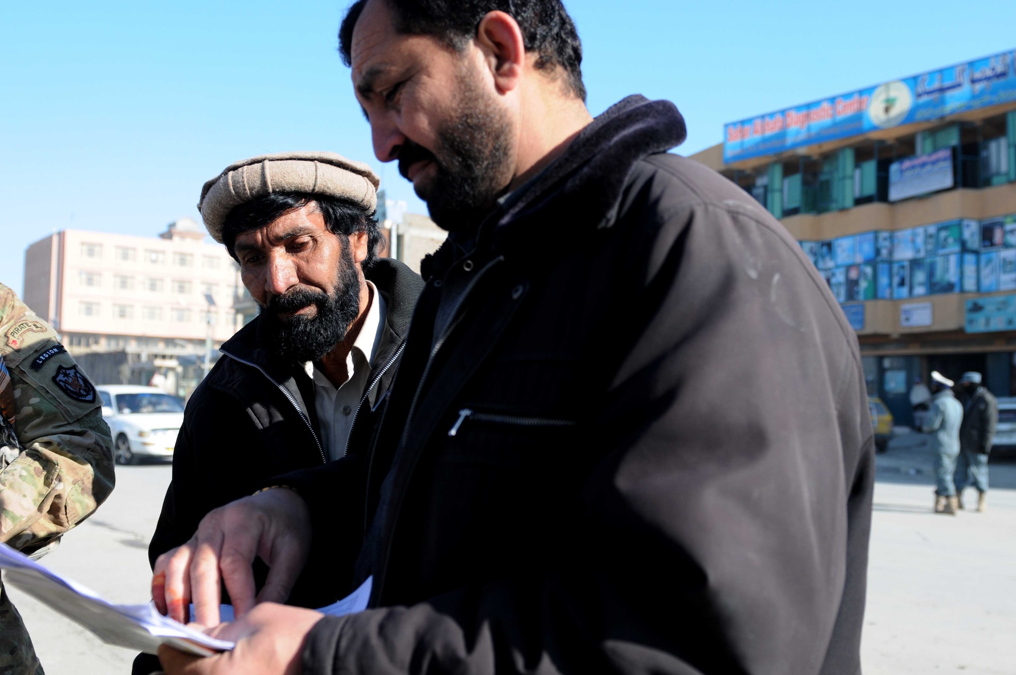 PAKTYA PROVINCE, Afghanistan - Laolo Edin (left), the Paktya Province director of power, and Engineer Wali, an Afghan contractor, discuss contractual conditions of an electricity project in Gardez City, Jan. 9, 2012. The project will affect about a 1.5-kilometer stretch of the road and will provide electricity for 300 to 400 shops, expanding economic opportunities in the city. (U.S. Air Force photo/1st Lt. Cammie Quinn)