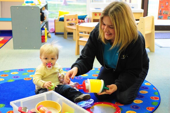 ROYAL AIR FORCE MENWITH HILL, United Kingdom -- Emma Bell, an Menwith Hill Station child development program assistant, plays with Delaney Wheeler, 1, at the CDC, Jan. 6. Bell performed life-saving abdominal thrusts on Delaney after food became stuck in her throat Jan. 4. Delaney is the child of Becky and Tech. Sgt. Justin Wheeler, 421st Air Base Group. (U.S. Air Force photo/Tech. Sgt. Todd Wivell)