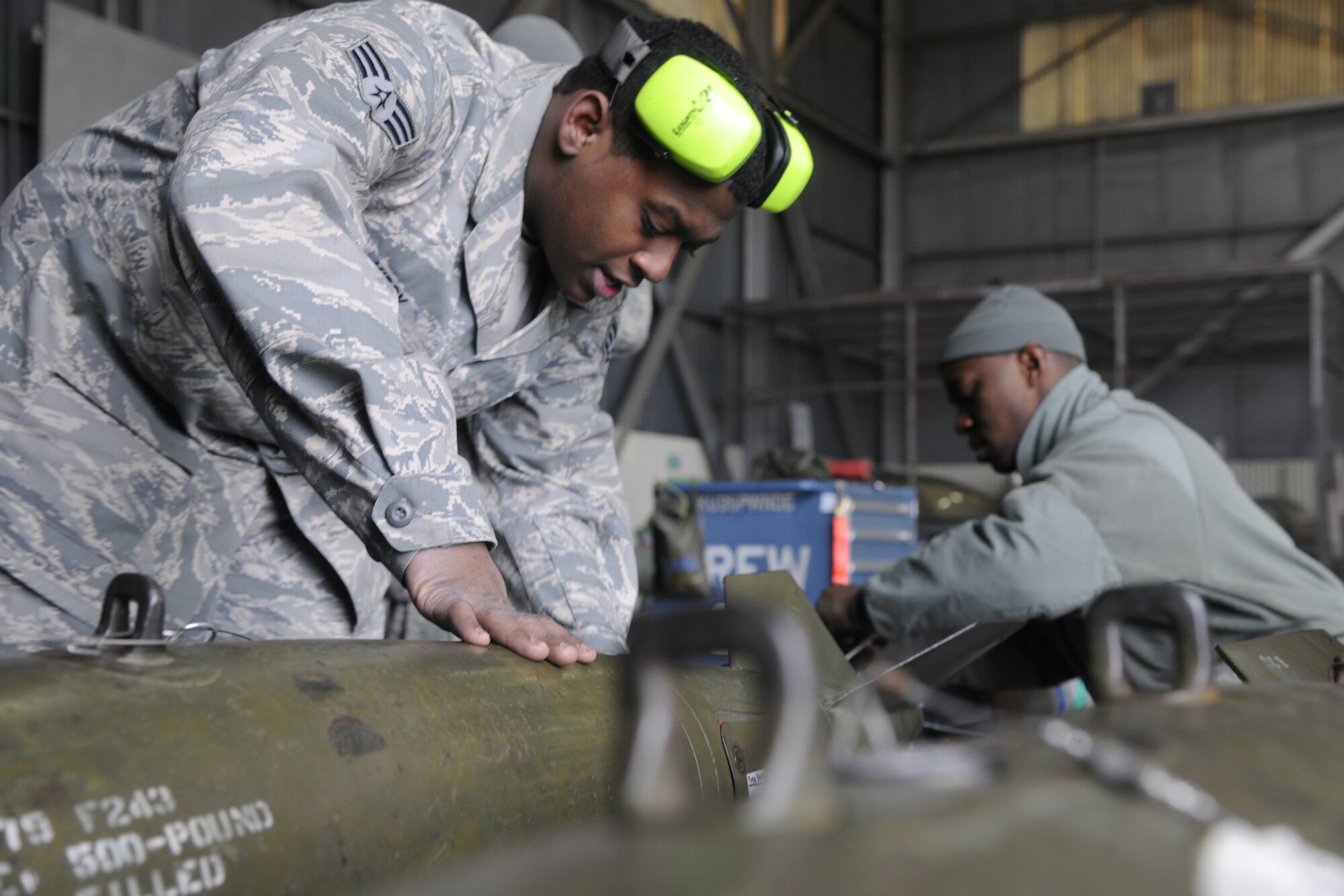 Senior Airman Demarcus Kirby and Staff Sgt. Kenneth Williams, 35th Aircraft Maintenance Unit weapons load crew members, prep weapons to be loaded on F-16 Fighting Falcons in a peninsula weapons loading competition at Kunsan Air Base, Republic of Korea, Jan. 11, 2012. Each team raced against time loading training weapons on their respective F-16 Fighting Falcons trying to minimize discrepancies. The training of the teams improves job performance, but it also fosters teamwork and camaraderie. (U.S. Air Force photo by Staff Sgt. Rasheen A. Douglas/Released)