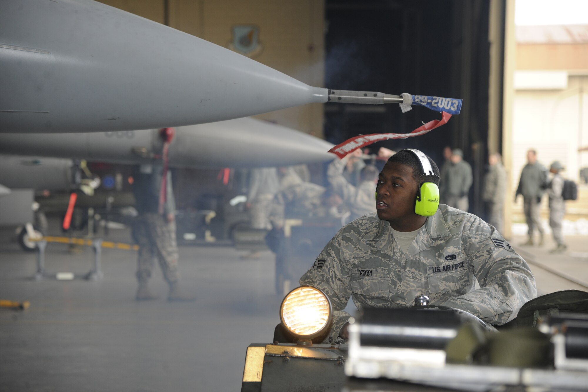 Senior Airman Demarcus Kirby, 35th Aircraft Maintenance Unit weapons load crew member, fires up an MJ1 bomb lift truck in preparation to load a weapon on an F-16 Fighting Falcon during a peninsula weapons loading competition at Kunsan Air Base, Republic of Korea, Jan. 11, 2012. Each team raced against time loading training weapons on their respective F-16 Fighting Falcons trying to minimize discrepancies. The training of the teams improves job performance, but it also fosters teamwork and camaraderie. (U.S. Air Force photo by Staff Sgt. Rasheen A. Douglas/Released)