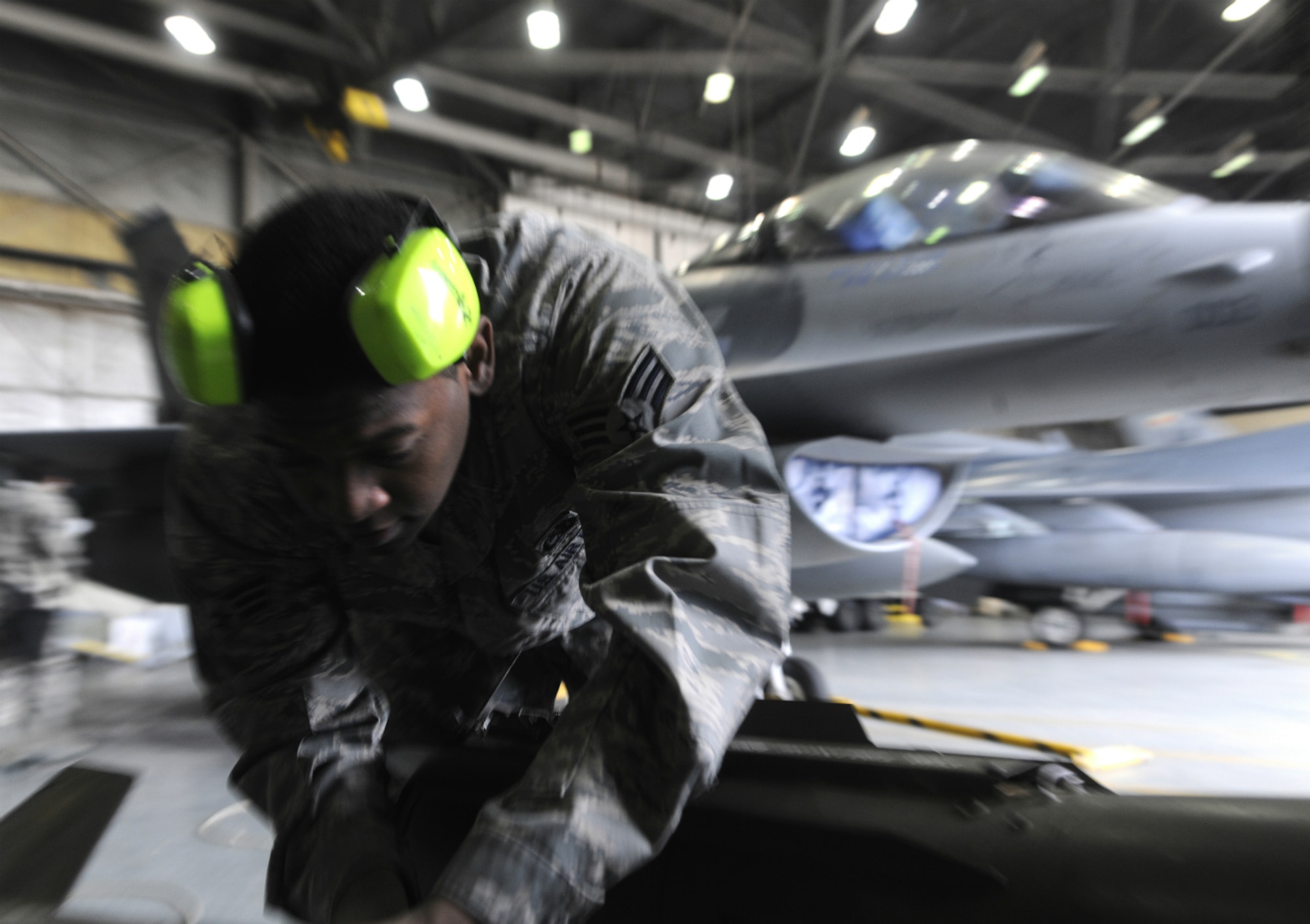 Senior Airman Demarcus Kirby, 35th Aircraft Maintenance Unit weapons load crew member, preps weapon to be loaded on an F-16 Fighting Falcon during a peninsula weapons loading competition at Kunsan Air Base, Republic of Korea, Jan. 11, 2012. Each team raced against time loading training weapons on their respective F-16 Fighting Falcons trying to minimize discrepancies. The training of the teams improves job performance, but it also fosters teamwork and camaraderie. (U.S. Air Force photo by Staff Sgt. Rasheen A. Douglas/Released)