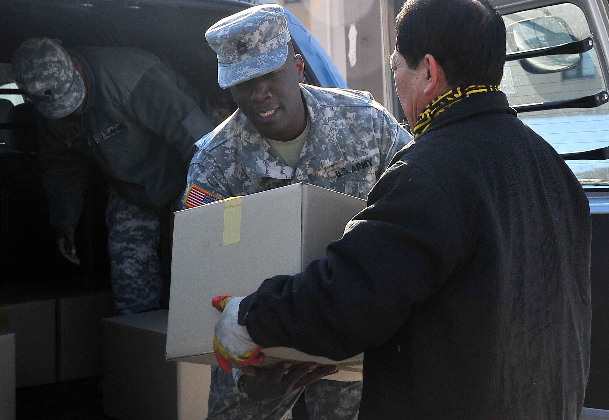 Sgt. 1st Class Sgt. 1st Class Jason Vigier, 19th Expeditionary Sustainment Command at Camp Henry, picks up boxes from the Korean Ministry of Patriots and Veterans, Jan. 12, 2012, to deliver to U.S. troops in Daegu, Korea. All service members stationed in the ROK received a special edition, framed portion of wire fence from the demilitarized zone that separates North and South Korea. (U.S. Air Force photo/ Staff Sgt. Stefanie Torres)