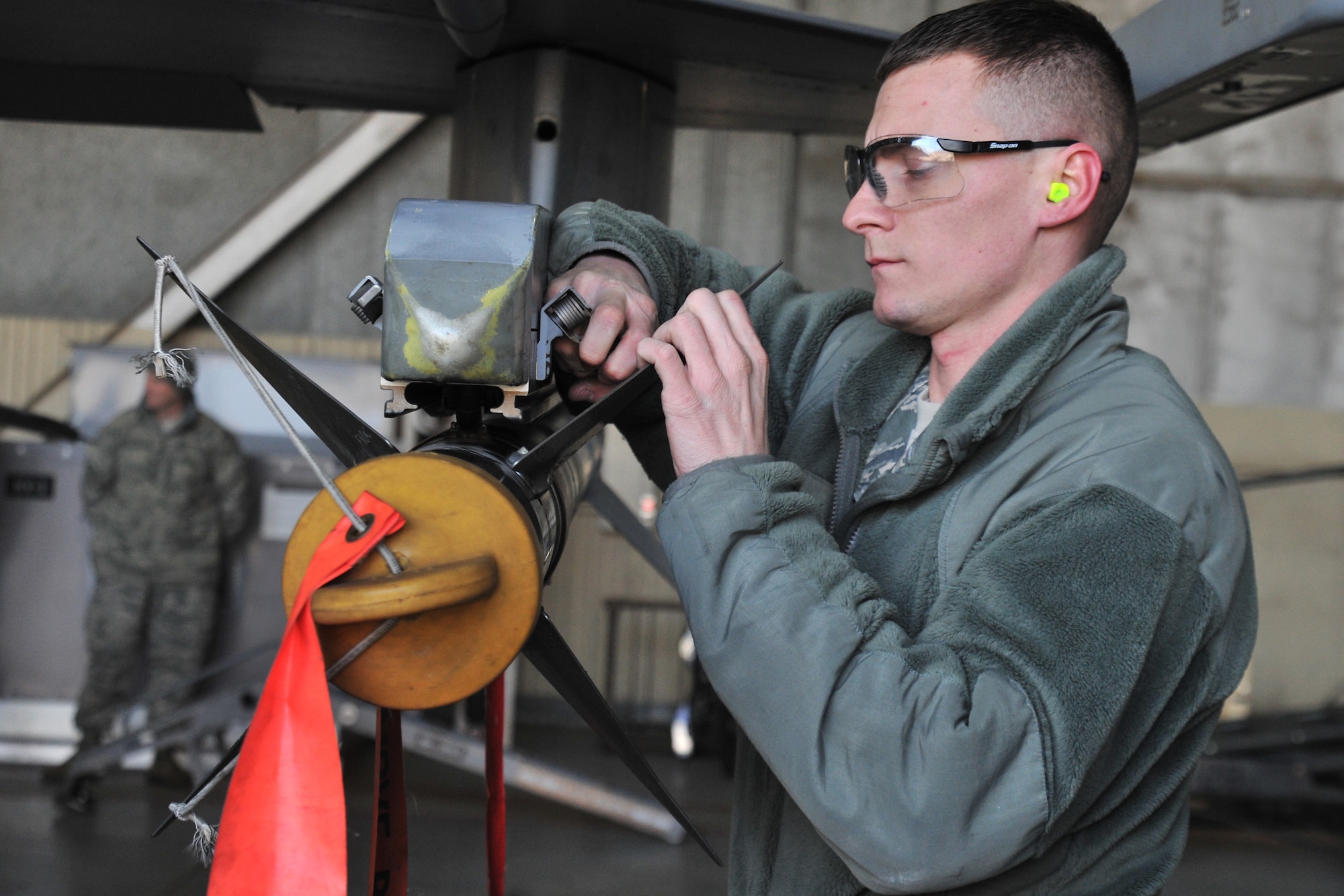 Senior Airman Daniel Rapp, 421st Aircraft Maintenance Unit load crew member, competes in the 4th quarter 8th Maintenance Group peninsula weapons loading competition at Kunsan Air Base, Republic of Korea, Jan. 11, 2012. The training of the teams improves job performance, but it also fosters teamwork and camaraderie. (U.S. Air Force photo by Senior Airman Brittany Y. Auld/Released)