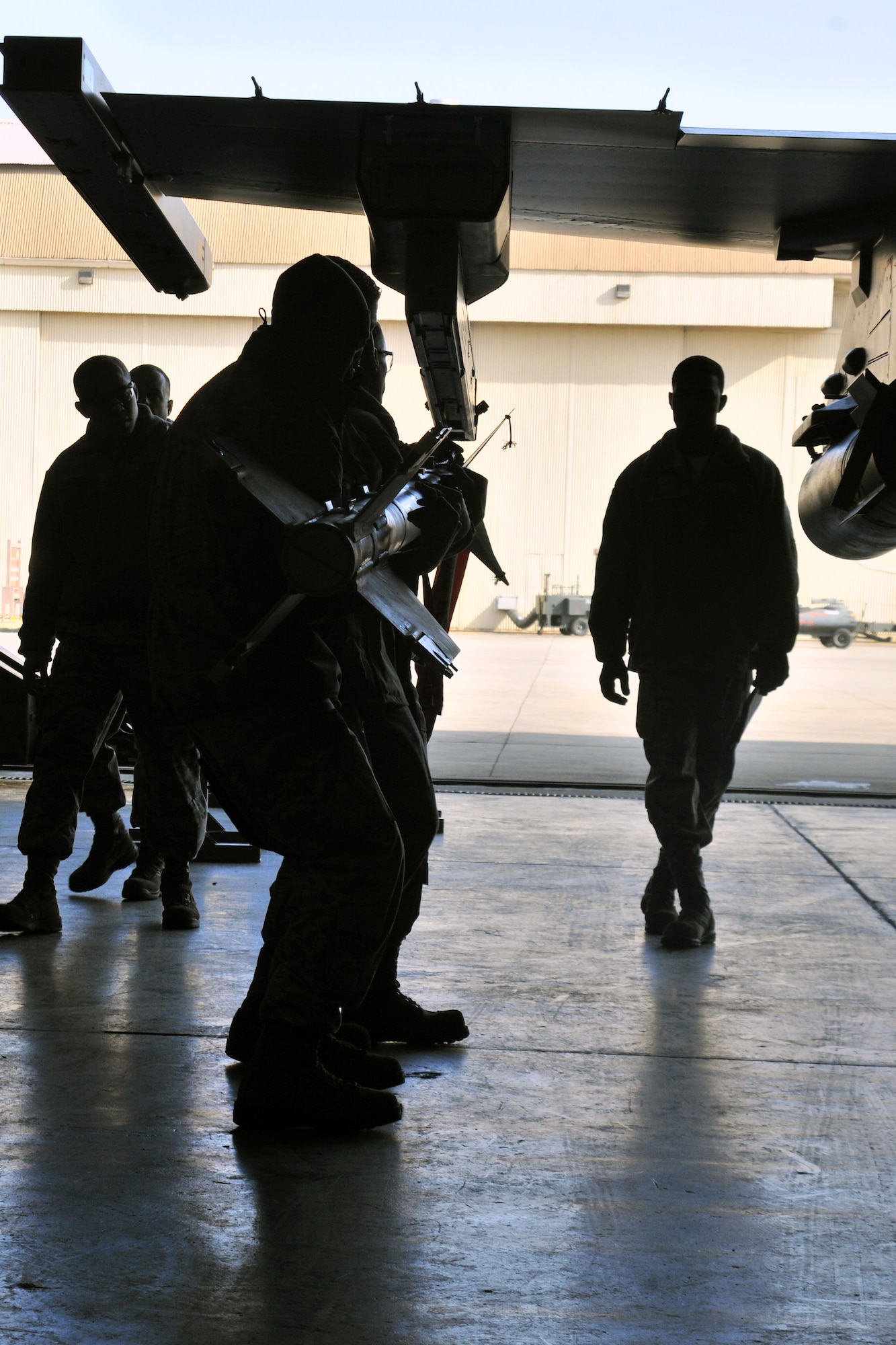 Load crew members from the 421st Aircraft Maintenance Unit compete in the 4th quarter 8th Maintenance Group peninsula weapons loading competition at Kunsan Air Base, Republic of Korea, Jan. 11, 2012. The training of the teams improves job performance, but it also fosters teamwork and camaraderie. (U.S. Air Force photo by Senior Airman Brittany Y. Auld/Released)