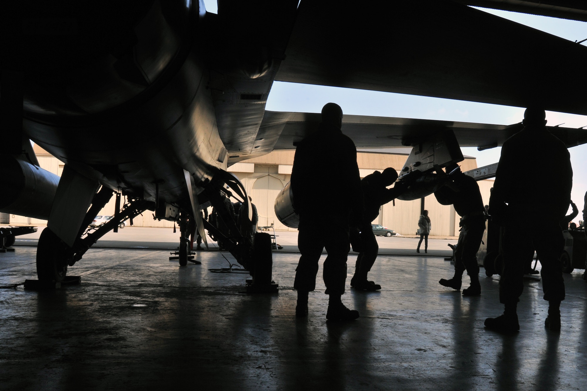 Senior Airman Daniel Rapp and Airman 1st Class Daniel Pas, 421st Aircraft Maintenance Unit load crew members, compete in the 4th quarter 8th Maintenance Group peninsula weapons loading competition at Kunsan Air Base, Republic of Korea, Jan. 11, 2012. Each team raced against time loading training weapons on their respective F-16 Fighting Falcons trying to minimize discrepancies. (U.S. Air Force photo by Senior Airman Brittany Y. Auld/Released)