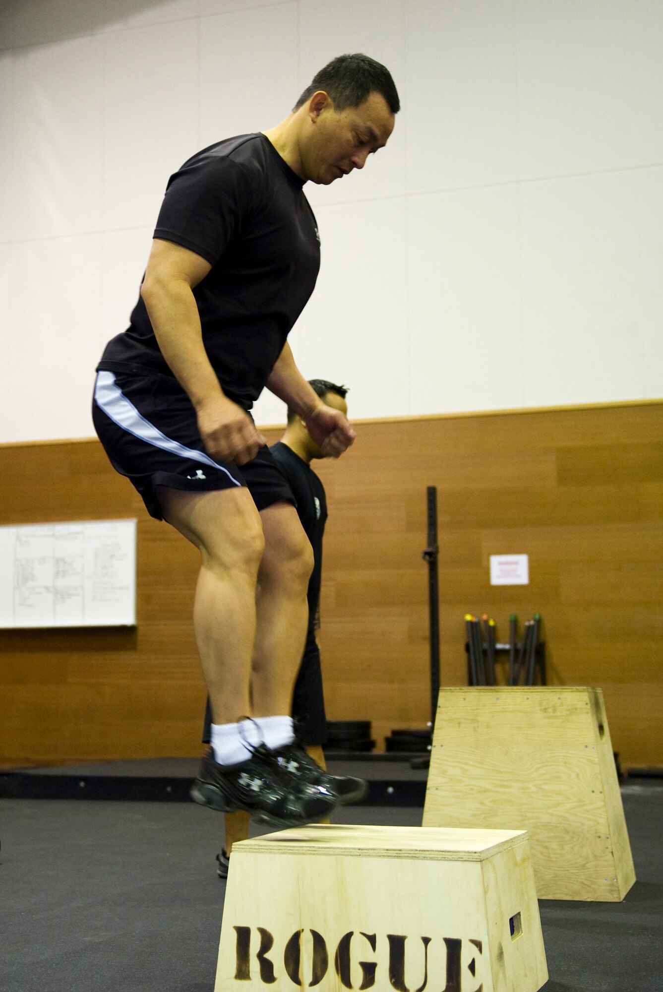 YOKOTA AIR BASE, Japan -- Benny Miguel, 374th Force Support Squadron, fitness center director, demonstrates box jumps at Yokota Air Base, Japan, Jan. 13, 2011. The exercise is part of the Samurai Fitness Center's Cross Training class which uses a variety of exercises varying with time, rounds and weight. (U.S. Air Force photo/Airman 1st Class John D. Partlow)