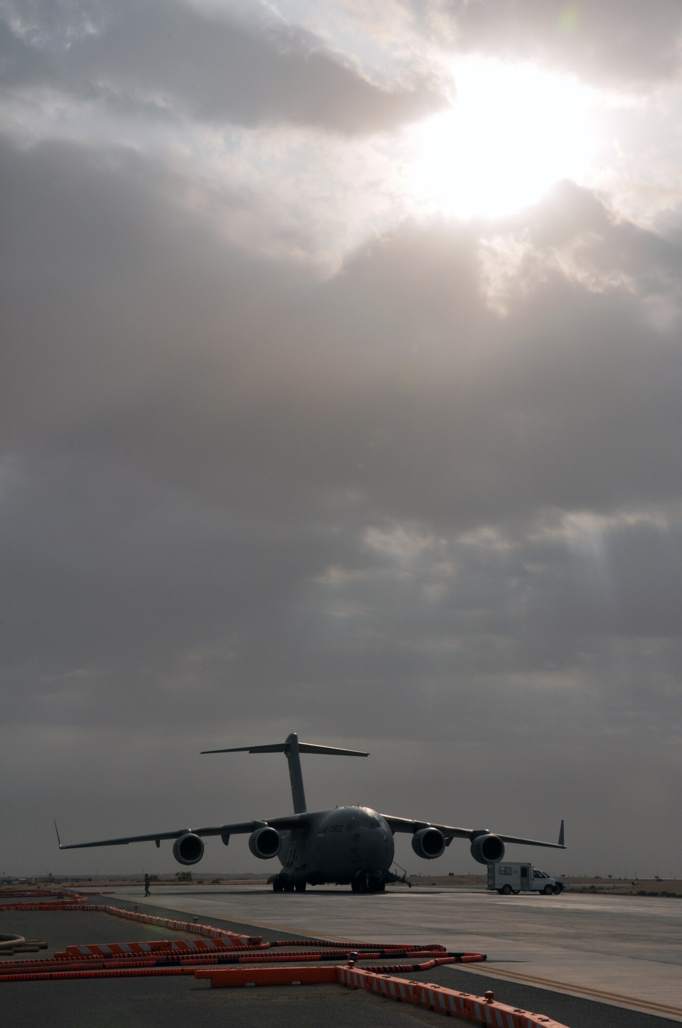 SOUTHWEST ASIA -- A C-17 Globemaster III with the 386th Expeditionary Wing sits in a patch of sun during an overcast day on the flightline at an undisclosed location Jan. 12, 2012.  The C-17 is the newest, most flexible aircraft to enter the airlift force.  Its abilities have become the lifeline for many larger loads brought into and out of the U.S. Central Command area of responsibility. (U.S. Air Force photo/Tech. Sgt. Stacy Fowler)