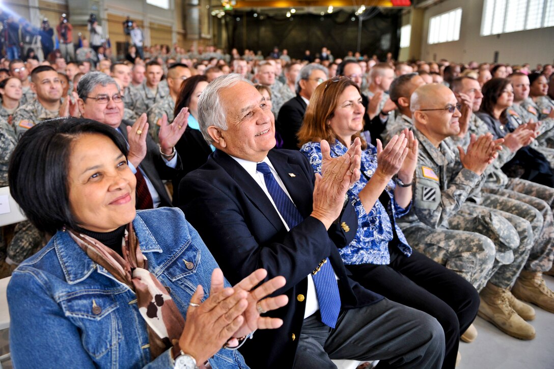 Troops and U.S. Rep. Silvestre Reyes of Texas, second from left, applaud as Defense Secretary Leon E. Panetta holds a town hall meeting during a trip to El Paso, Texas, Jan. 12, 2012.
