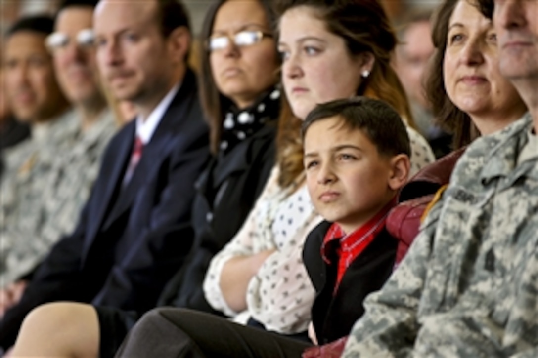 A child of a service member looks on as Defense Secretary Leon E. Panetta speaks on Fort Bliss near El Paso, Texas, Jan. 12, 2012.