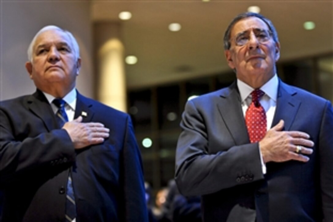Defense Secretary Leon E. Panetta, right, and U.S. Rep. Silvestre Reyes of Texas stand during the singing of the national anthem at the beginning of a dinner sponsored by the El Paso Chamber of Commerce in El Paso, Texas, Jan. 12, 2012.