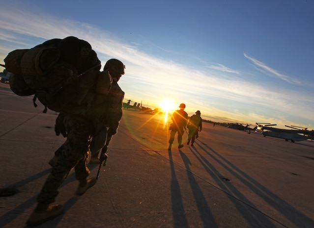 Marines and Sailors with Bravo Company, Battalion Landing Team 1st Battalion, 2nd Marine Regiment, 24th Marine Expeditionary Unit, make their way towards a CH-53E Super Stallion with Marine Medium Tiltrotor Squadron VMM-261 (Reinforced), 24th MEU, prior to conducting a simulated an air field seizure at the Farmville Municipal Airport Jan. 13, 2012. The 24th MEU is participating in their Realistic Urban Training (RUT) exercise, scheduled from Jan. 5-20, which has the unit conducting off-base missions near the town of Farmville to prepare for the various missions they may face during deployment.