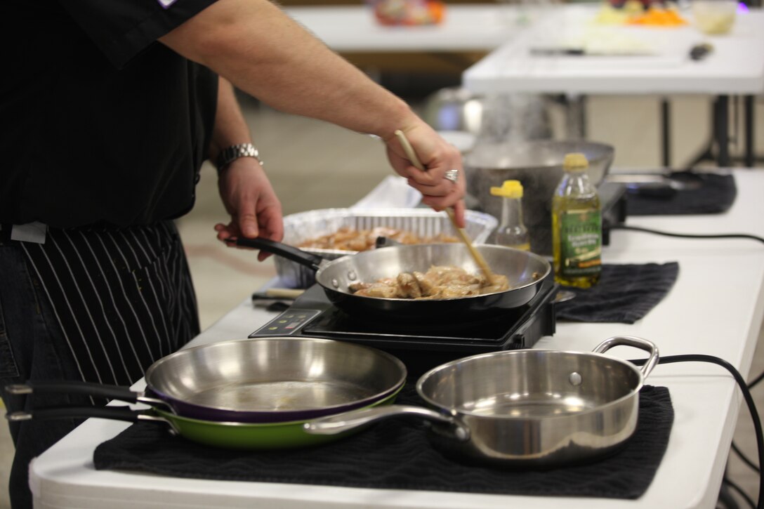 Chef Terry Rademann cooks chicken during Midway Parks Community Center’s Cooking Class in Midway Park, a housing community of Marine Corps Base Camp Lejeune, Jan. 14. During this month’s class Rademann taught participants how to make a stir-fry.