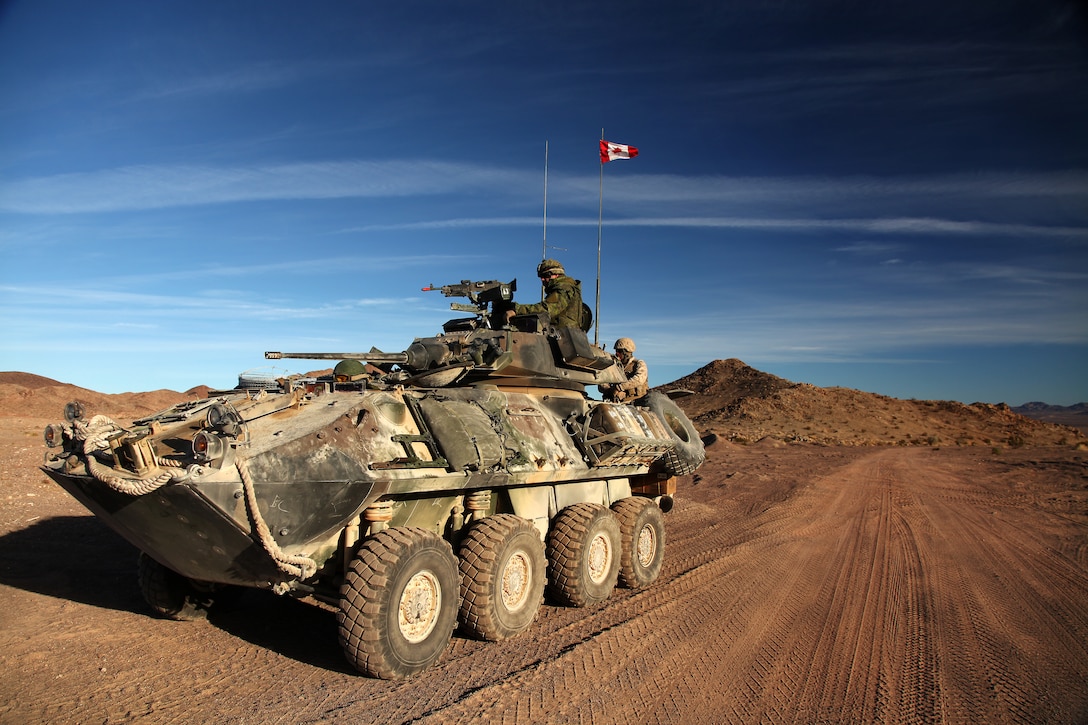 Canadian Cpl. Gabriel Dufou, Squadron B, 12th Regiment Blinde du Canada translated as 12th Armored Regiment of Canada, and U. S. Marine Lance Cpl. Daniel Gwiazdowski, 3rd Light Armored Reconnaissance Battalion, await their next orders in their LAV-25 Jan. 14. They were participating in a joint rehearsal exercise known as Desert Fighter/Baroudeur at the Combat Center’s training area.