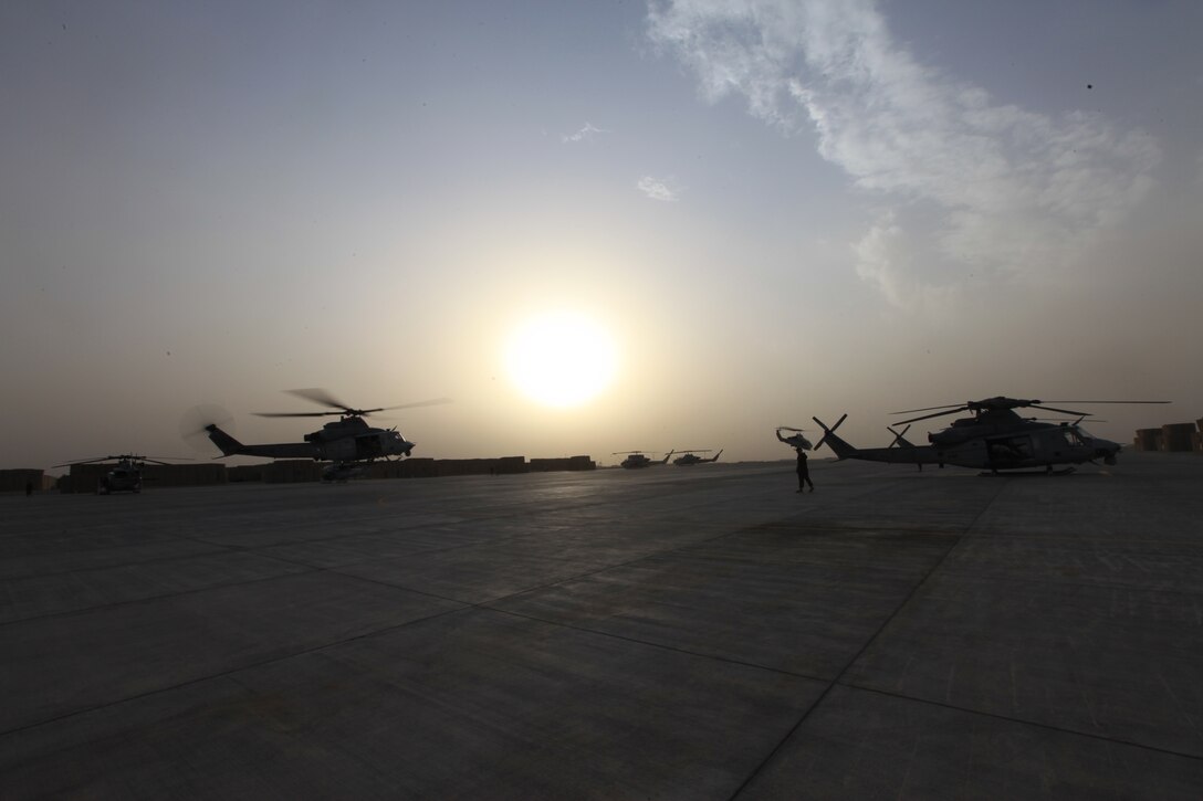 A UH-1Y Huey and AH-1W Super Cobra with Marine Light Attack Helicopter Squadron 369, nicknamed the "Gunfighters," depart Camp Bastion, Afghanistan, Jan. 14. The squadron wields the only Marine Corps attack helicopters in Afghanistan and provides close-air support for coalition forces conducting counterinsurgency operations.::r::::n::