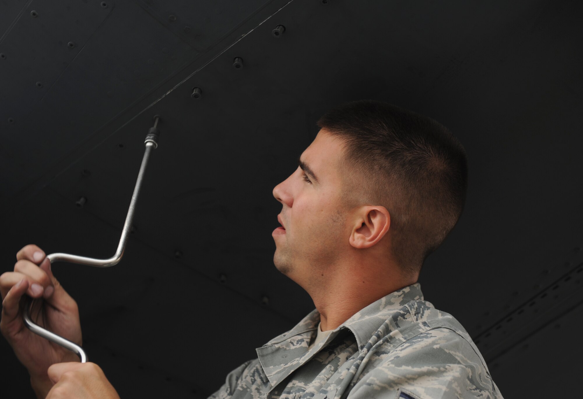 SOUTHWEST ASIA – Staff Sgt. Jesse Hutchings, 379th Expeditionary Maintenance Squadron aero-repair technician and native of Tacoma, Wash., closes a panel after aligning a crew entry ladder on a B-1B Lancer here Jan. 13, 2012. Aero-repair technicians perform heavy maintenance on aircraft, including technical processes that require technical skills beyond unit-level capabilities. (U.S. Air Force photo/Staff Sgt. Nathanael Callon)