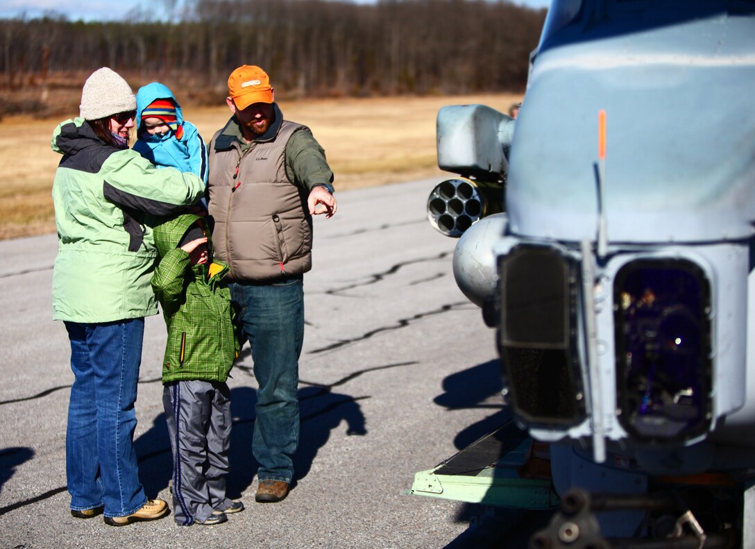 Local citizens from the Farmville, Va. area, look at an AH-1 Cobra with Marine Medium Tiltrotor Squadron VMM-261 (Reinforced), 24th Marine Expeditionary Unit at Farmville Municipal Airport during the Marine Corps Community Day Jan. 14, 2012. The 24th MEU organized the event as part of their Realistic Urban Training exercise (RUT) to thank the community and highlight the capabilities of the Marine Air Ground Task Force. The RUT exercise is scheduled from Jan. 5-20, and is meant to allow the Marines to conduct off-base training near the town of Farmville to prepare for their upcoming deployment.