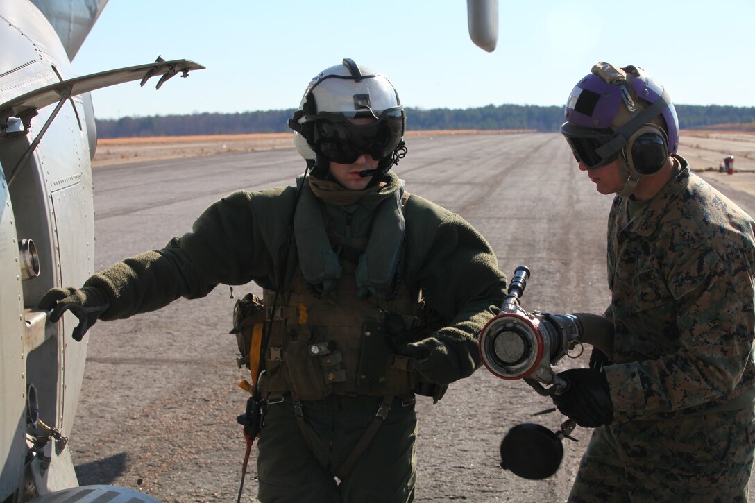 (Right) Lance Cpl. Nicholas Verdisco, a bulk fuel specialist with Marine Medium Tiltrotor Squadron VMM-261 (Reinforced), 24th Marine Expeditionary Unit, prepares to fuel an MV-22 Osprey with a Helicopter Expedient Refueling System, here, Jan. 14, 2012. The Marines refueled the aircraft to support a simulated airfield seizure at Farmville Municipal Airport as part of the 24th MEU’s Realistic Urban Training (RUT) exercise scheduled Jan. 5-20. RUT focuses on conducting off-base missions near the town of Farmville, Va., to prepare for the various operations they may conduct during their upcoming deployment.
