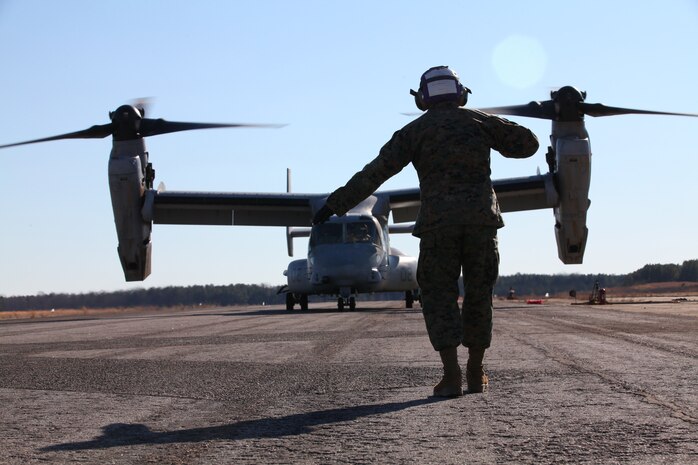 Lance Cpl. Nicholas Verdisco, bulk fuel specialist with Marine Medium Tiltrotor Squadron VMM-261 (Reinforced), 24th Marine Expeditionary Unit, directs an MV-22 Osprey to move right before takeoff, here, Jan. 14, 2012. The Marines refueled the aircraft to support a simulated airfield seizure at Farmville Municipal Airport, which is part of Realistic Urban Training (RUT) exercise scheduled Jan. 5-20. RUT focuses on conducting off-base missions near the town of Farmville, Va., to prepare for the various operations they may conduct during their upcoming deployment.