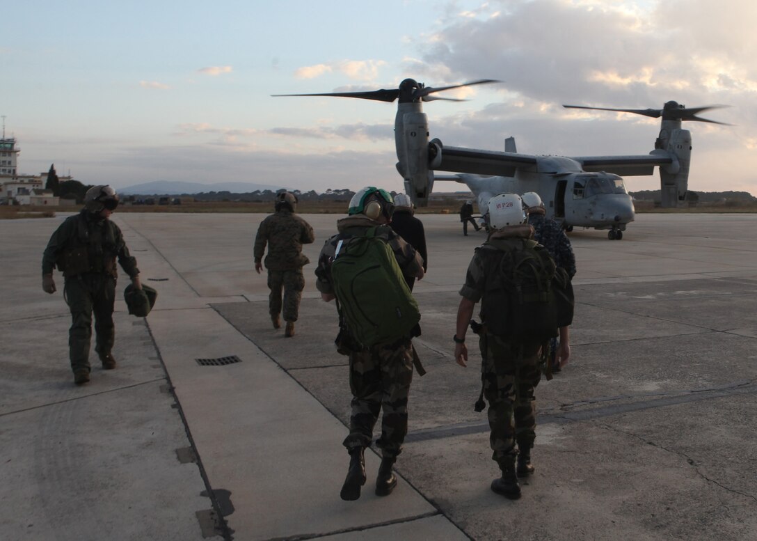 French military representatives and U.S. Embassy, Paris representatives walk to an MV-22 Osprey, with Marine Medium Tilt Rotor Squadron 263 (Reinforced), 22nd Marine Expeditionary Unit (MEU), aboard Toulon-Hyéres International Airport, Jan. 14, 2012. Twelve French military representatives flew to USS Bataan to learn about and inspect the MV-22 Osprey to ensure the Osprey could be cross-decked to French ships in future operations. The Marines and sailors of the 22nd MEU are currently deployed with Amphibious Squadron 6 aboard the USS Bataan Amphibious Ready Group.  The 22nd MEU is a multi-mission, capable force, comprised of an Aviation Combat Element, Marine Medium Tilt Rotor Squadron 263 (Reinforced); a Logistics Combat Element, Combat Logistics Battalion 22; a Ground Combat Element, Battalion Landing Team, 2nd Battalion, 2nd Marine Regiment; and its Command Element.