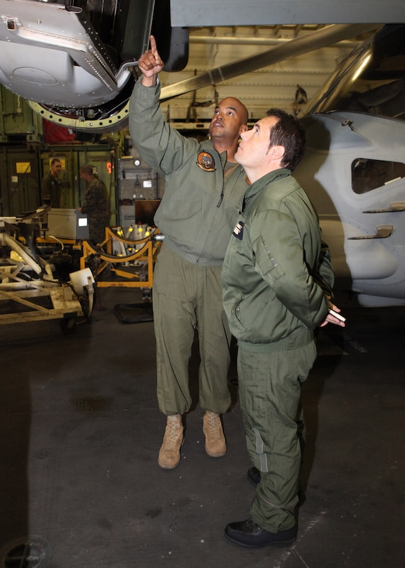 Gunnery Sgt. Vincent Burgess, left, the quality assurance chief with Marine Medium Tilt Rotor Squadron 263 (Reinforced), 22nd Marine Expeditionary Unit (MEU), explains parts of an MV-22 Osprey to a French military representative aboard USS Bataan, Jan. 14, 2012. Twelve French military representatives flew to USS Bataan to learn about and inspect MV-22 Ospreys to ensure the Osprey could be cross-decked to French ships in future operations. The Marines and sailors of the 22nd MEU are currently deployed with Amphibious Squadron 6 aboard the USS Bataan Amphibious Ready Group.  The 22nd MEU is a multi-mission, capable force, comprised of an Aviation Combat Element, Marine Medium Tilt Rotor Squadron 263 (Reinforced); a Logistics Combat Element, Combat Logistics Battalion 22; a Ground Combat Element, Battalion Landing Team, 2nd Battalion, 2nd Marine Regiment; and its Command Element.