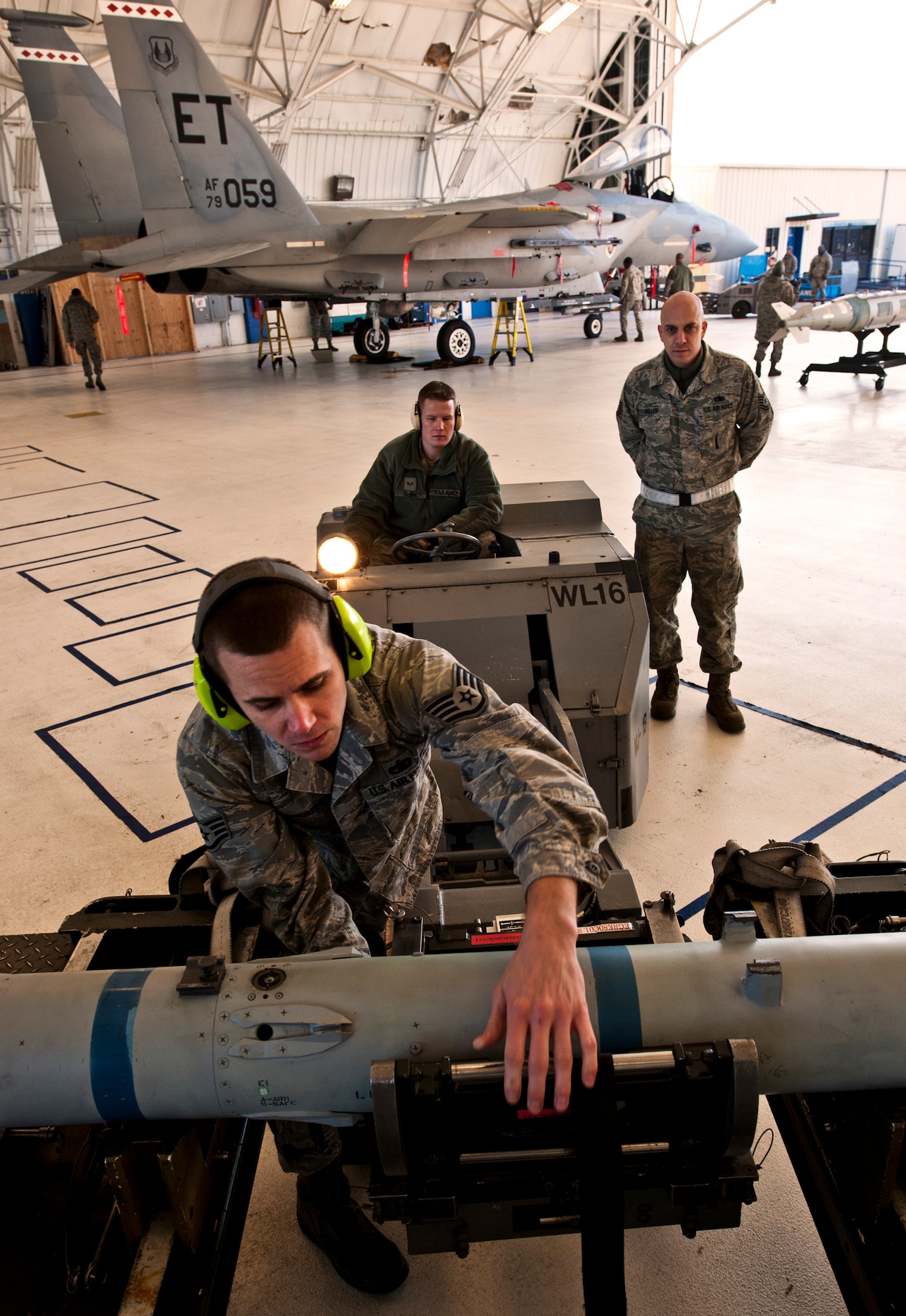 Staff Sgt. Kenneth Merritt, a 46th Aircraft Maintenance Squadron crew leader, secures the AIM-9 missile  before moving it to the jet Jan. 13 during the 46th Maintenance Group's year-end weapons load competition at Eglin Air Force Base, Fla.  The best of the best from 46th AMXS met to load a Joint Direct Attack Munition and AIM-9 and a small diameter bomb onto an F-15. The winners will be announced at the 46th MXG annual awards banquet in March. (U.S. Air Force photo/Samuel King Jr.) 