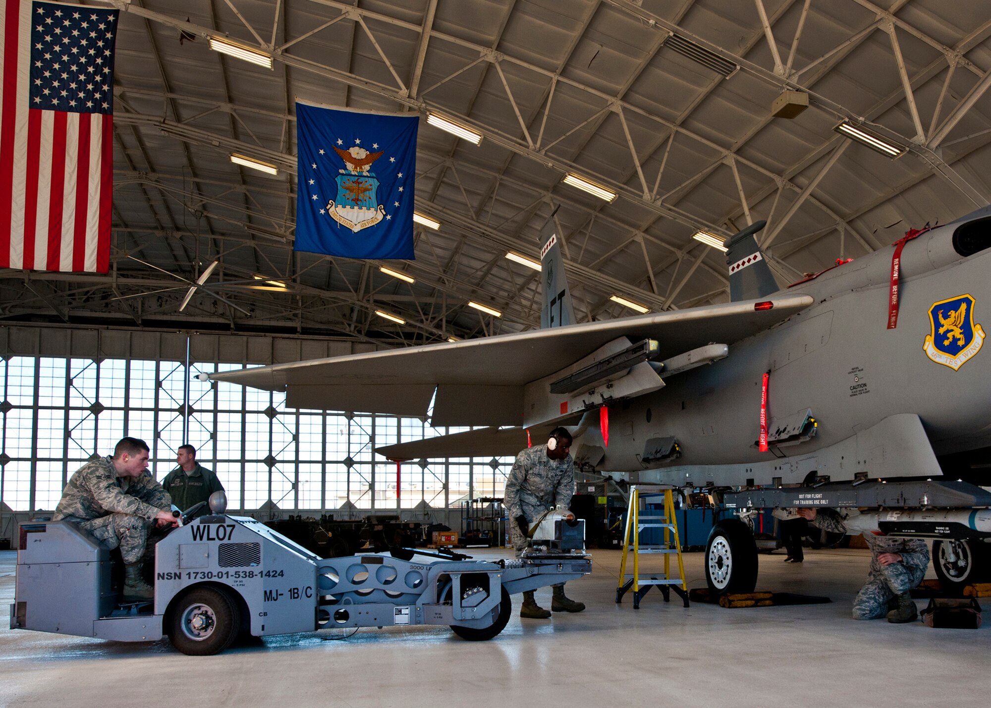 Staff Sgt. Anthony Childers, a 46th Aircraft Maintenance Squadron crew leader, guides his loader carrying a small diameter bomb into position during the 46th Maintenance Group’s year-end weapons load competition at Eglin Air Force Base, Fla., Jan. 13. The best of the best from 46th AMXS met to load a Joint Direct Attack Munition and AIM-9 and a SDB onto an F-15. The winners will be announced at the 46th MXG annual awards banquet in March. (U.S. Air Force photo/Samuel King Jr.)