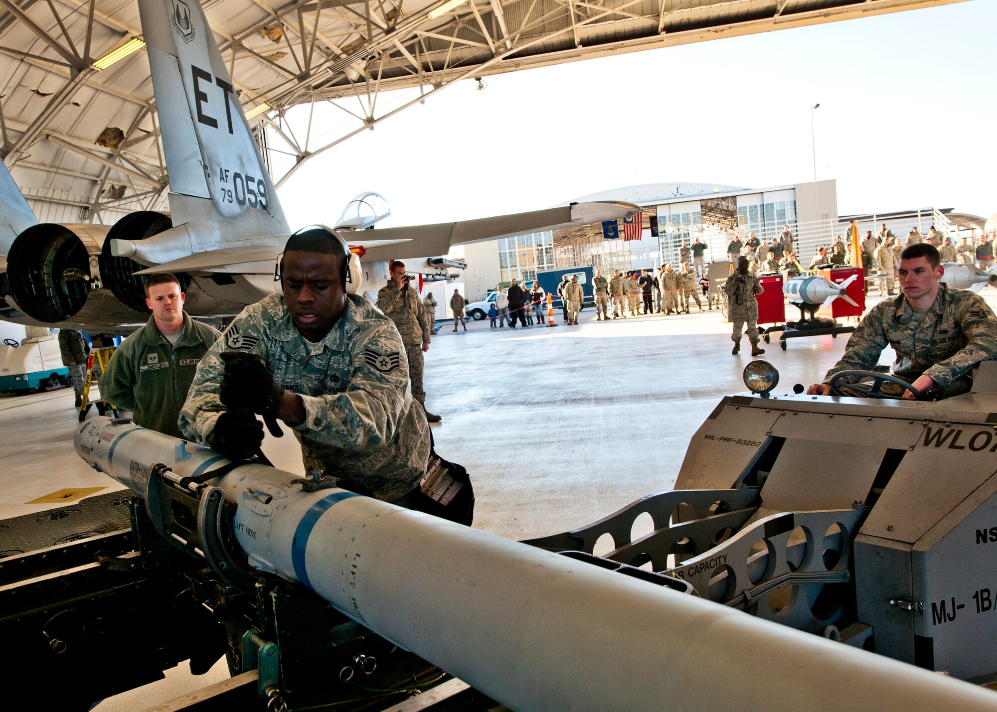 Staff Sgt. Anthony Childers, a 46th Aircraft Maintenance Squadron crew leader, secures the AIM-9 missile before moving it to the F-15 during the 46th Maintenance Group’s year-end weapons load competition at Eglin Air Force Base, Fla., Jan 13. The best of the best from 46th AMXS met to load a Joint Direct Attack Munition and AIM-9 and a small diameter bomb onto an F-15. The winners will be announced at the 46th MXG annual awards banquet in March. (U.S. Air Force photo/Samuel King Jr.)