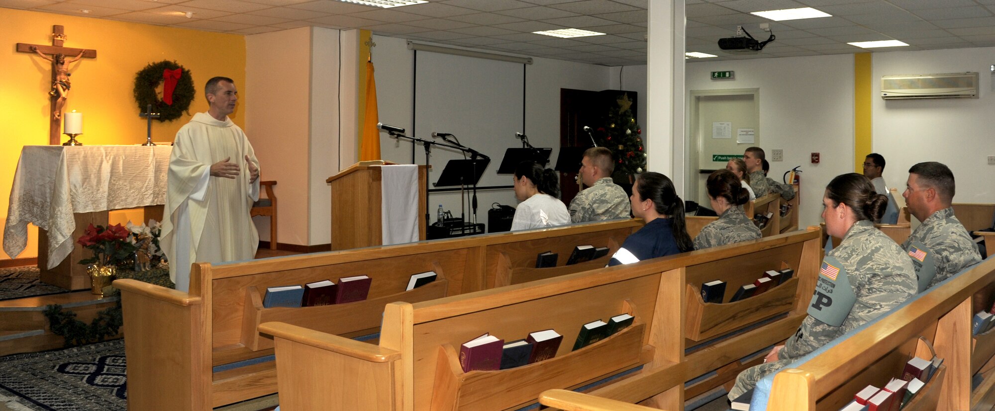 SOUTHWEST ASIA - Chaplain (Lt. Col.) Michael Butler speaks at Catholic Mass services at the 380th Air Expeditionary Wing sanctuary Dec. 31, 2011. Butler is deployed from the Missouri Air National Guard. (U.S. Air Force photo/Tech. Sgt. Arian Nead)  