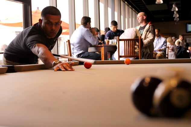A marine plays pool during a "Game Day" event hosted by the Real Warriors Campaign at Camp Pendleton's South Mesa Club, Jan. 15. Former players from the NFL Players Association came to base to discuss common reintegration challenges service members are faced with as well as the tools and resources available to address them.