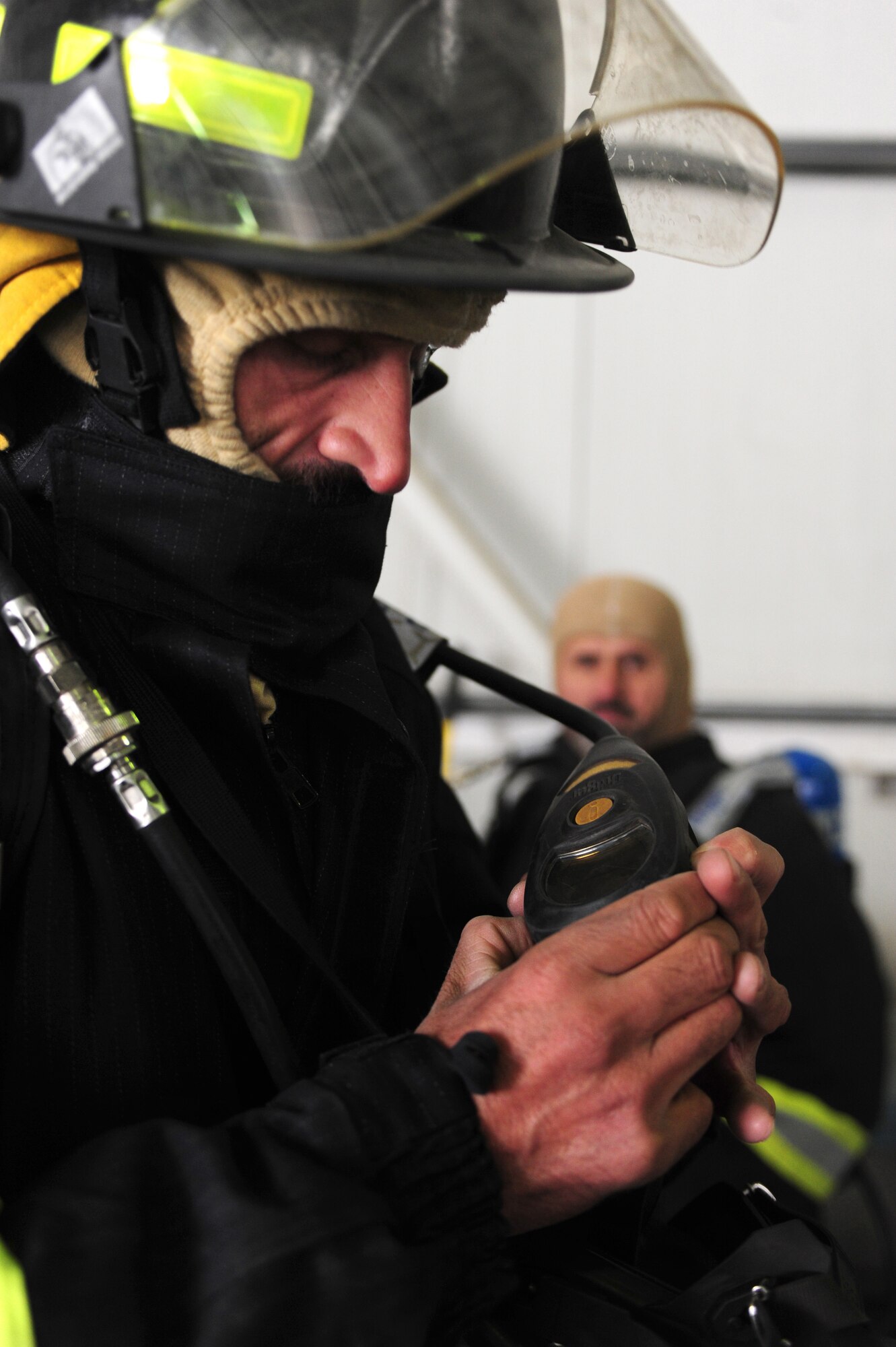 An Afghan air force firefighter performs an operations check of his personal protective equipment prior to a live fire exercise at the Air University Fire Academy, Kabul International Airport, Jan. 15, 2012. The firefighters participated in a three day course that included training on controlled fires, donning of protective equipment and training on safety procedures used in a controlled environment under the supervision of U.S. Air Force advisors.  (Photo by Staff Sgt. Nadine Y. Barclay) 