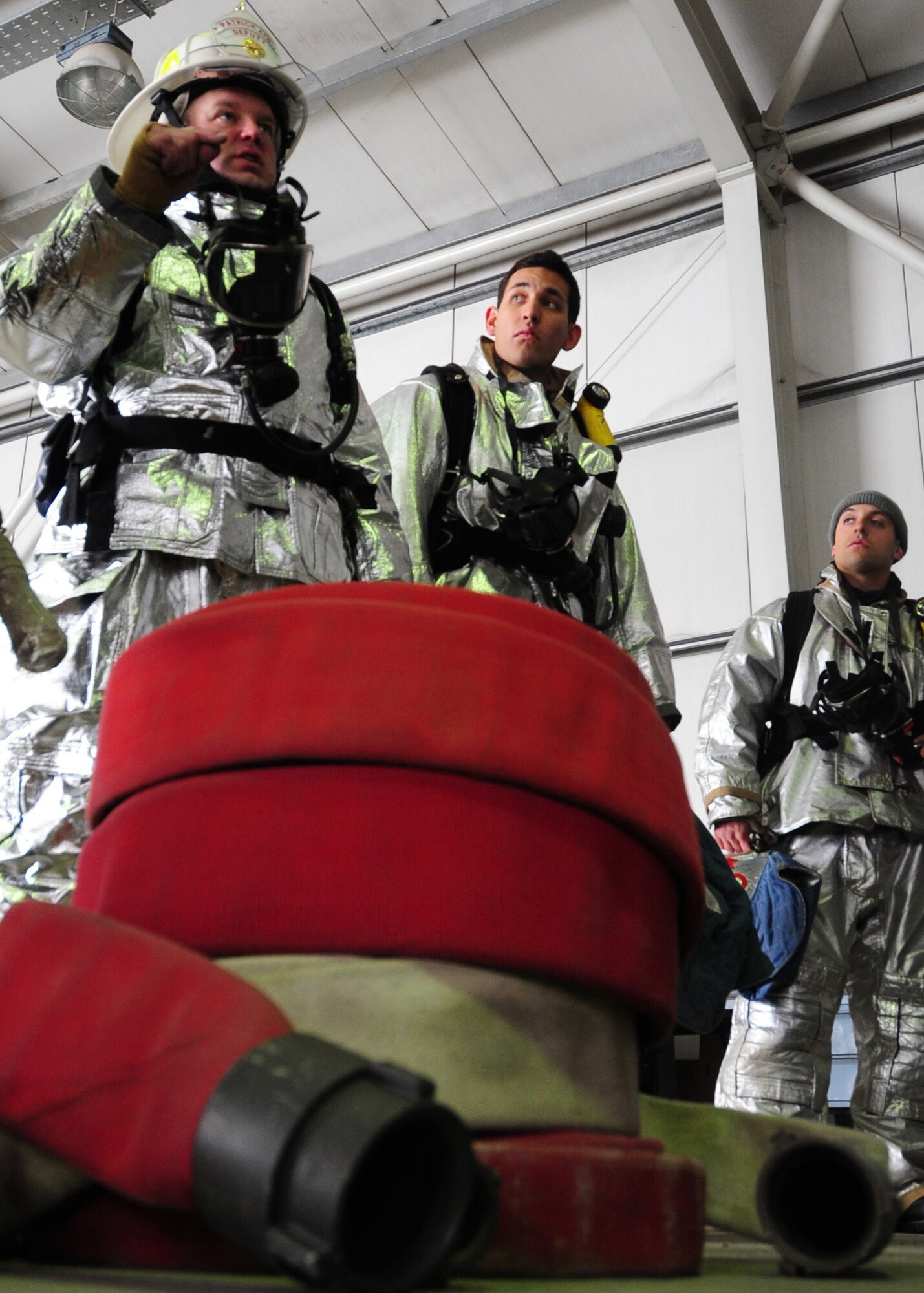 Advisors assigned to the 439th Air Expeditionary Advisory Squadron, discuss safety procedures to be followed by Afghan army and air force firefighters during a live fire training exercise at Kabul International Airport, Jan. 15, 2012.  (Photo by Staff Sgt. Nadine Y. Barclay)